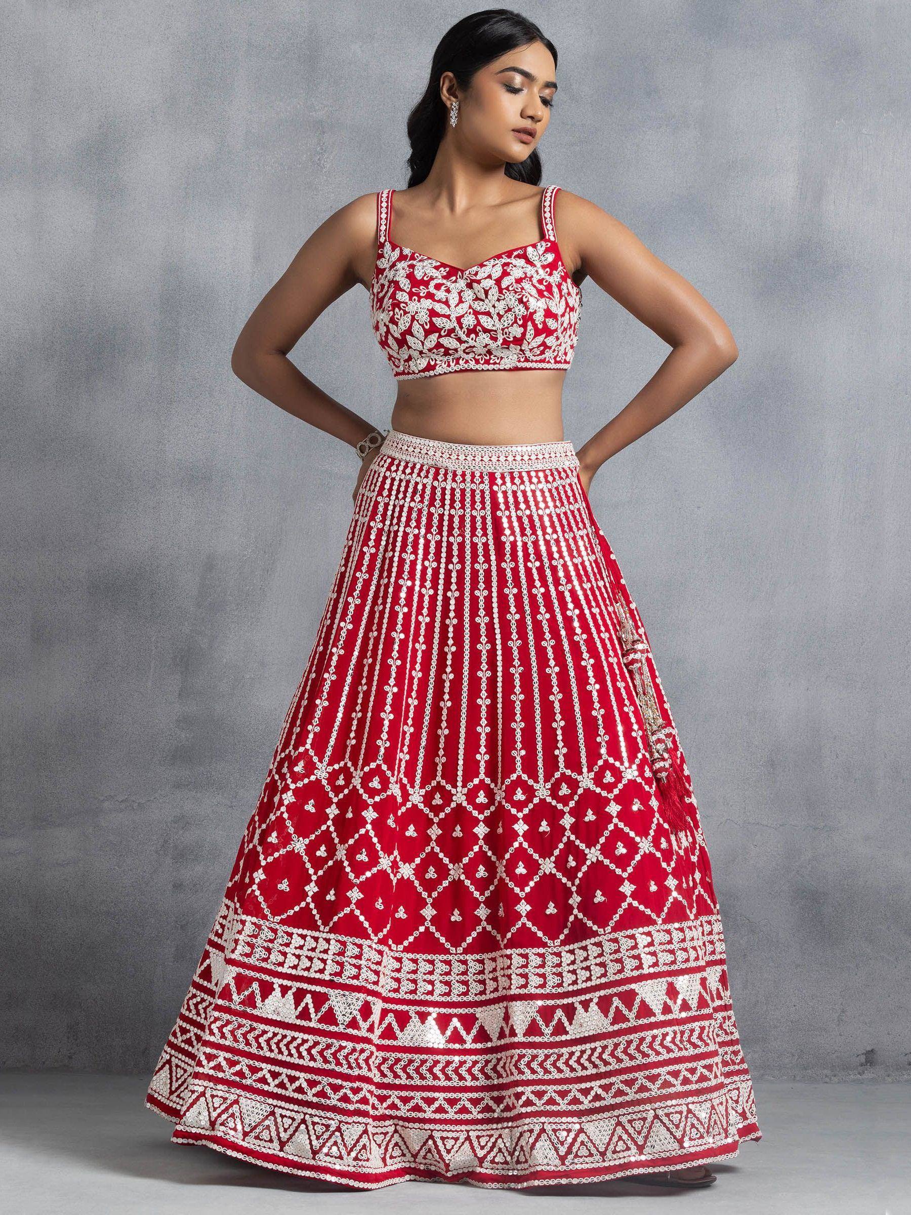 Red and white embroidered lehenga choli with floral and geometric patterns, perfect for Indian ethnic wear
