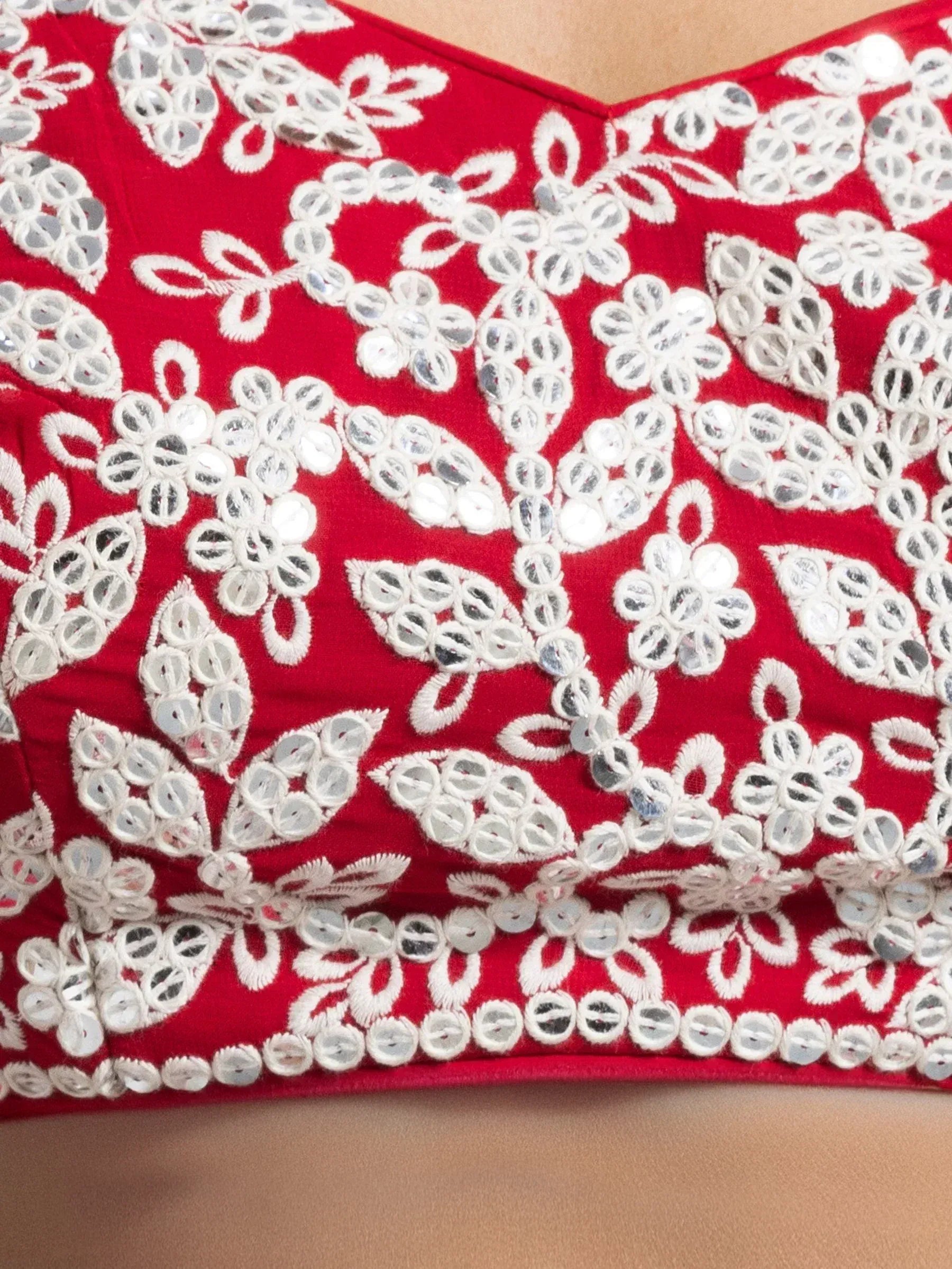 Red ethnic blouse with white floral embroidery and mirror work, perfect for lehenga choli sets