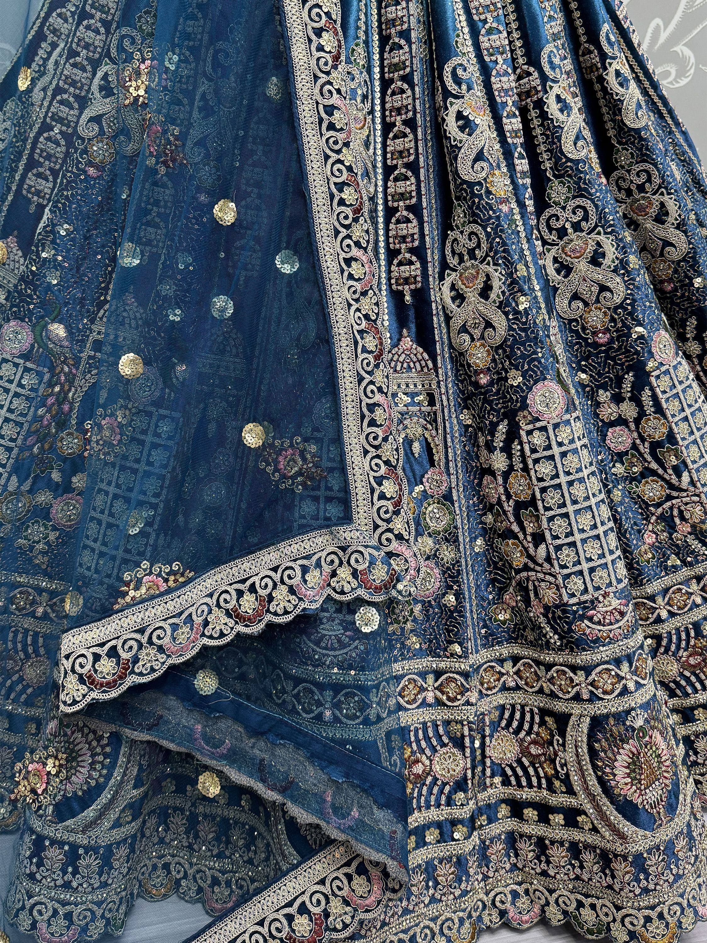 Blue embroidered lehenga choli with intricate gold and floral detailing, perfect for Indian ethnic wear.