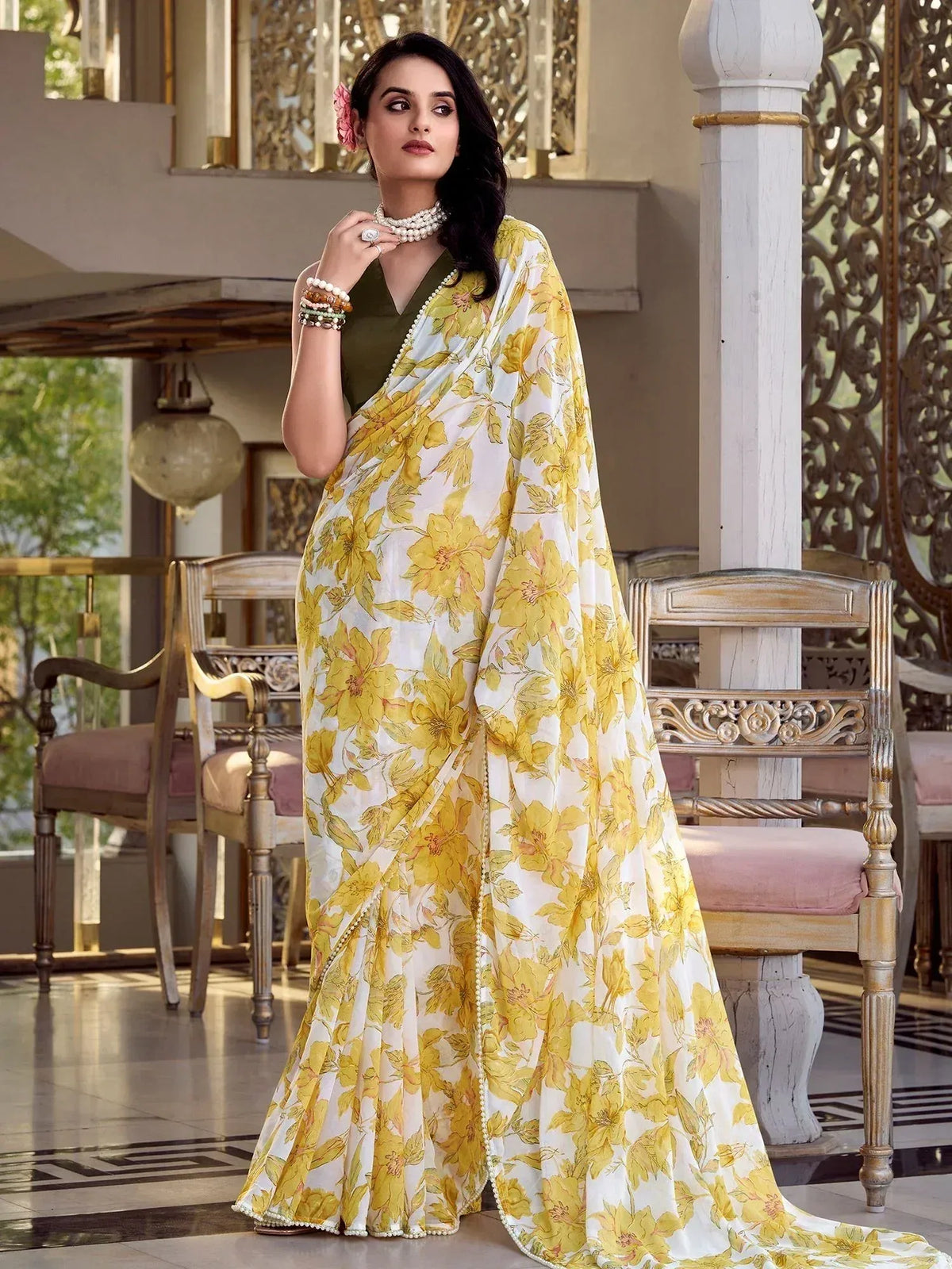 Yellow floral print saree with pearl border, styled with olive blouse and traditional jewelry for ethnic occasions