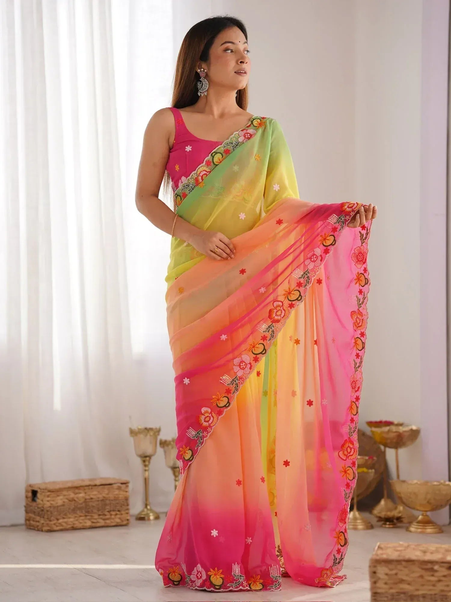 Woman in vibrant floral embroidered saree with pink, yellow, and green ombre design, perfect for Indian ethnic occasions