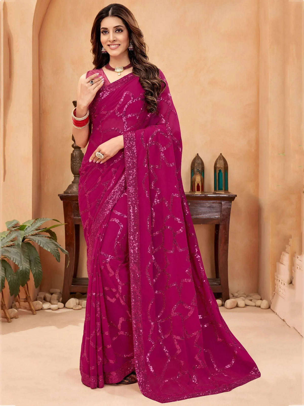 Woman in elegant magenta saree with sequin embroidery, perfect for Indian ethnic occasions