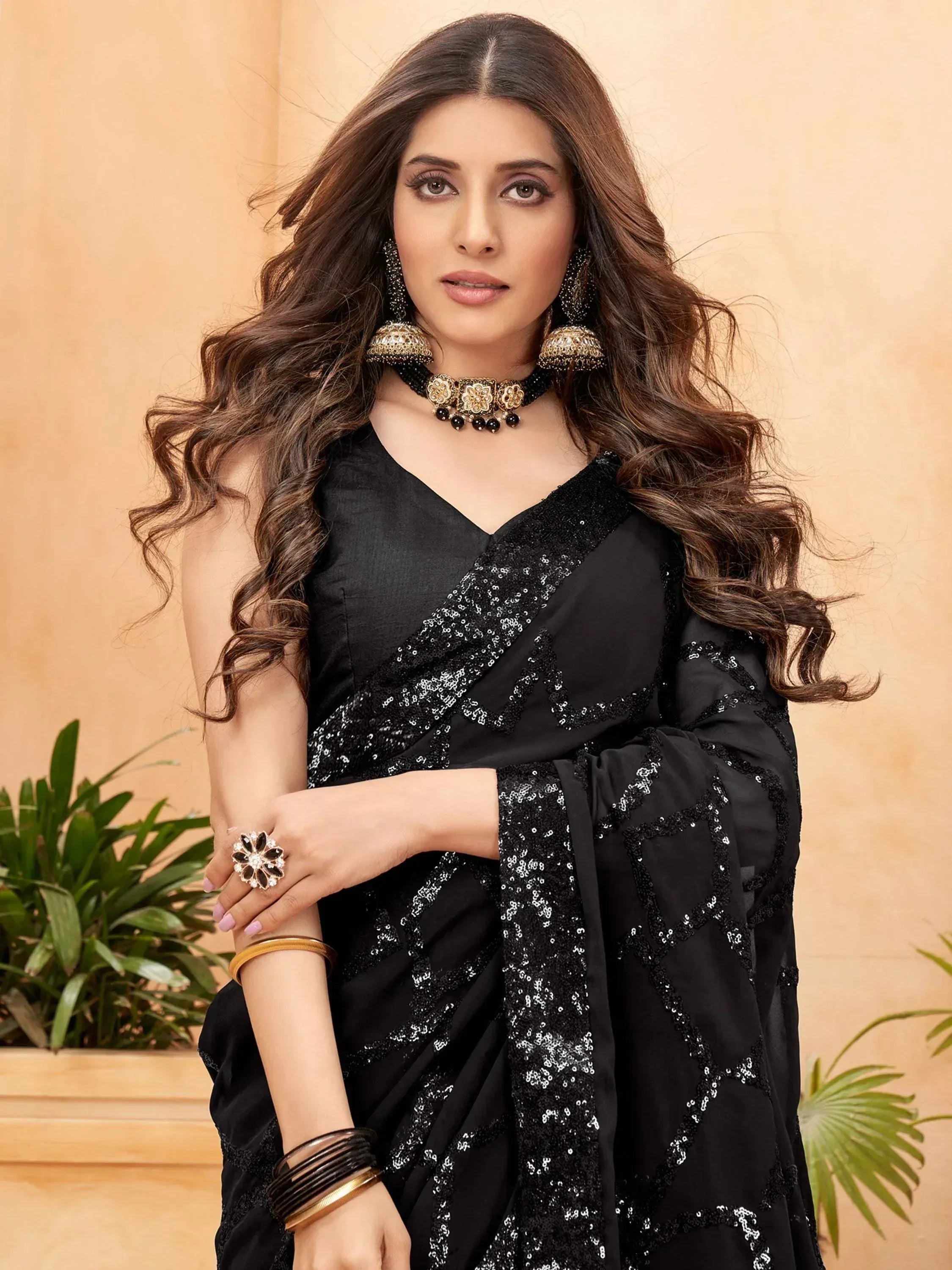 Elegant black sequin saree with V-neck blouse, perfect for Indian ethnic occasions and festive events.