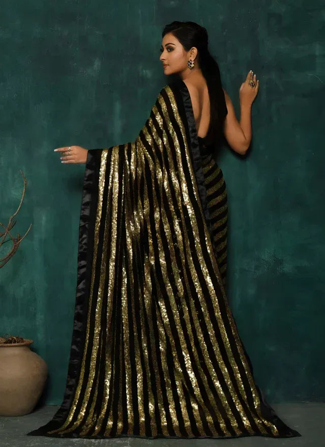 Black and gold striped sequin saree with open back, elegant ethnic wear for women