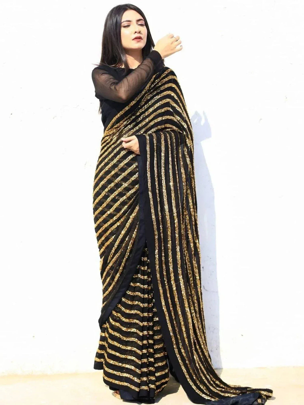 Black and gold striped saree with sheer blouse, elegant ethnic wear for women