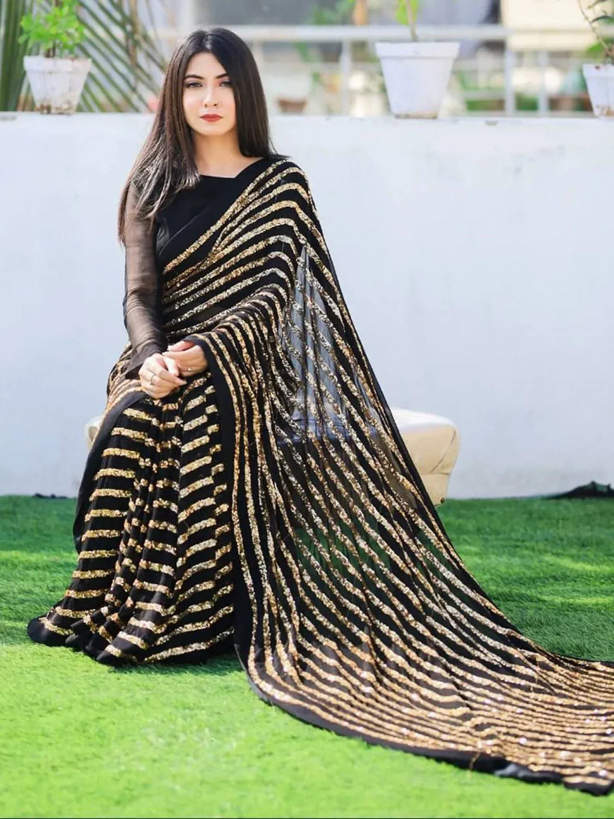 Black and gold striped saree with sheer sleeves, elegant ethnic wear for women
