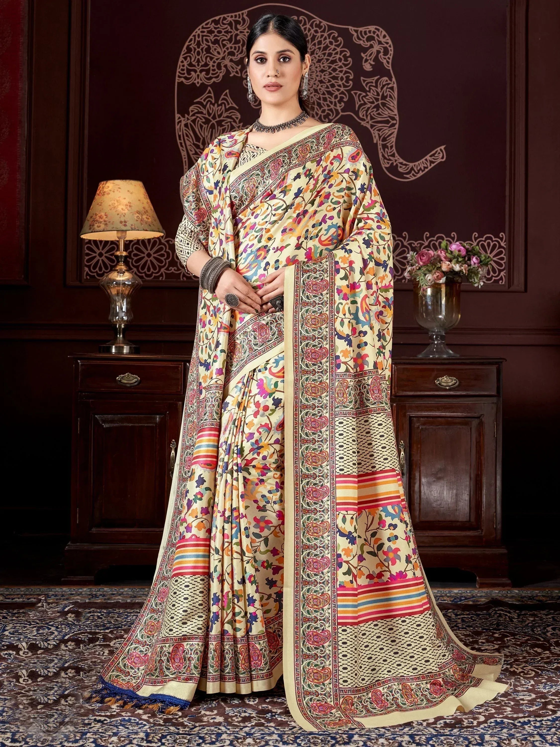 Woman in colorful floral printed Indian saree with paisley border, ethnic wear for festive occasions