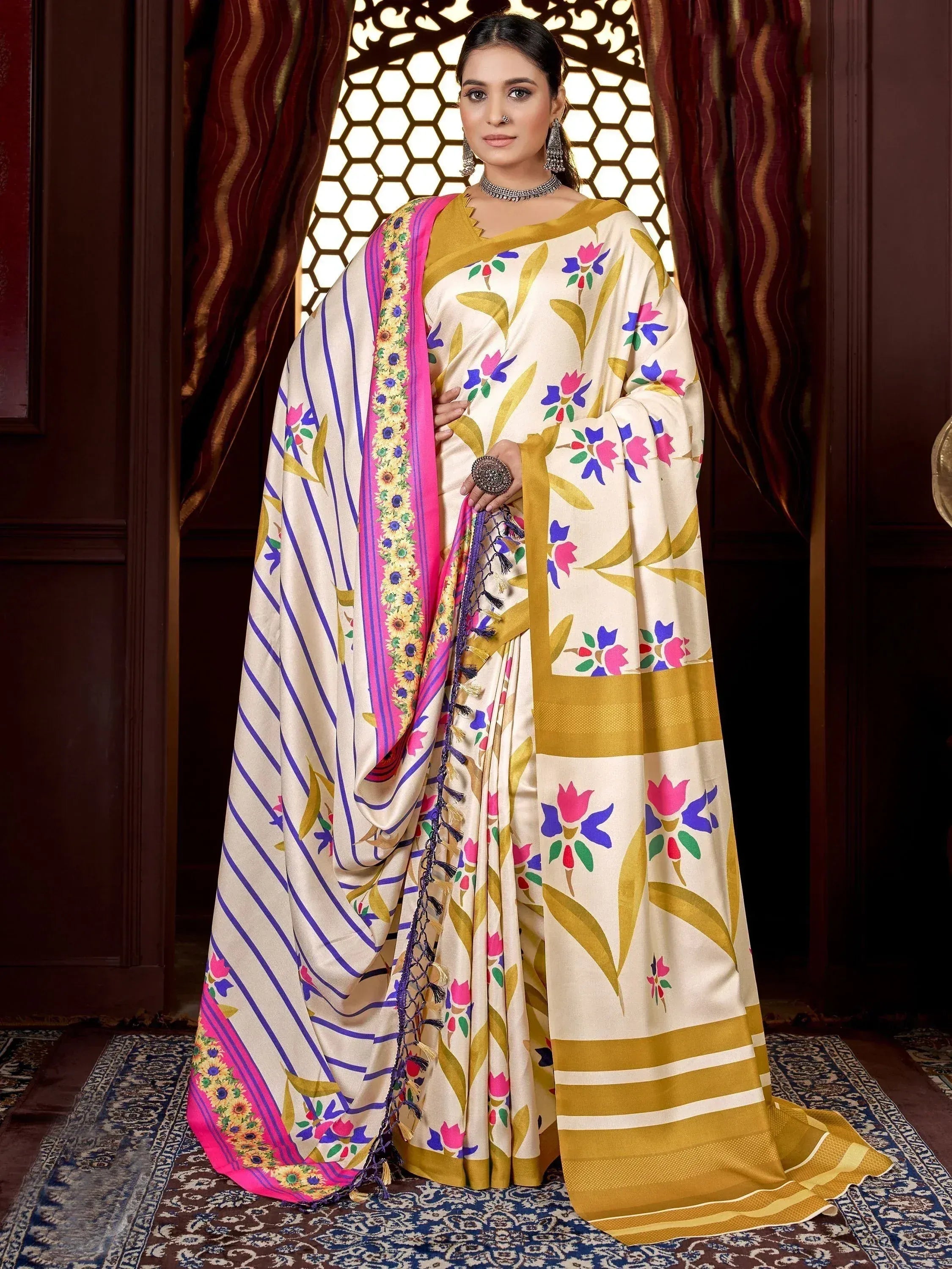Floral print ethnic saree with pink border and gold accents, perfect for Indian occasions