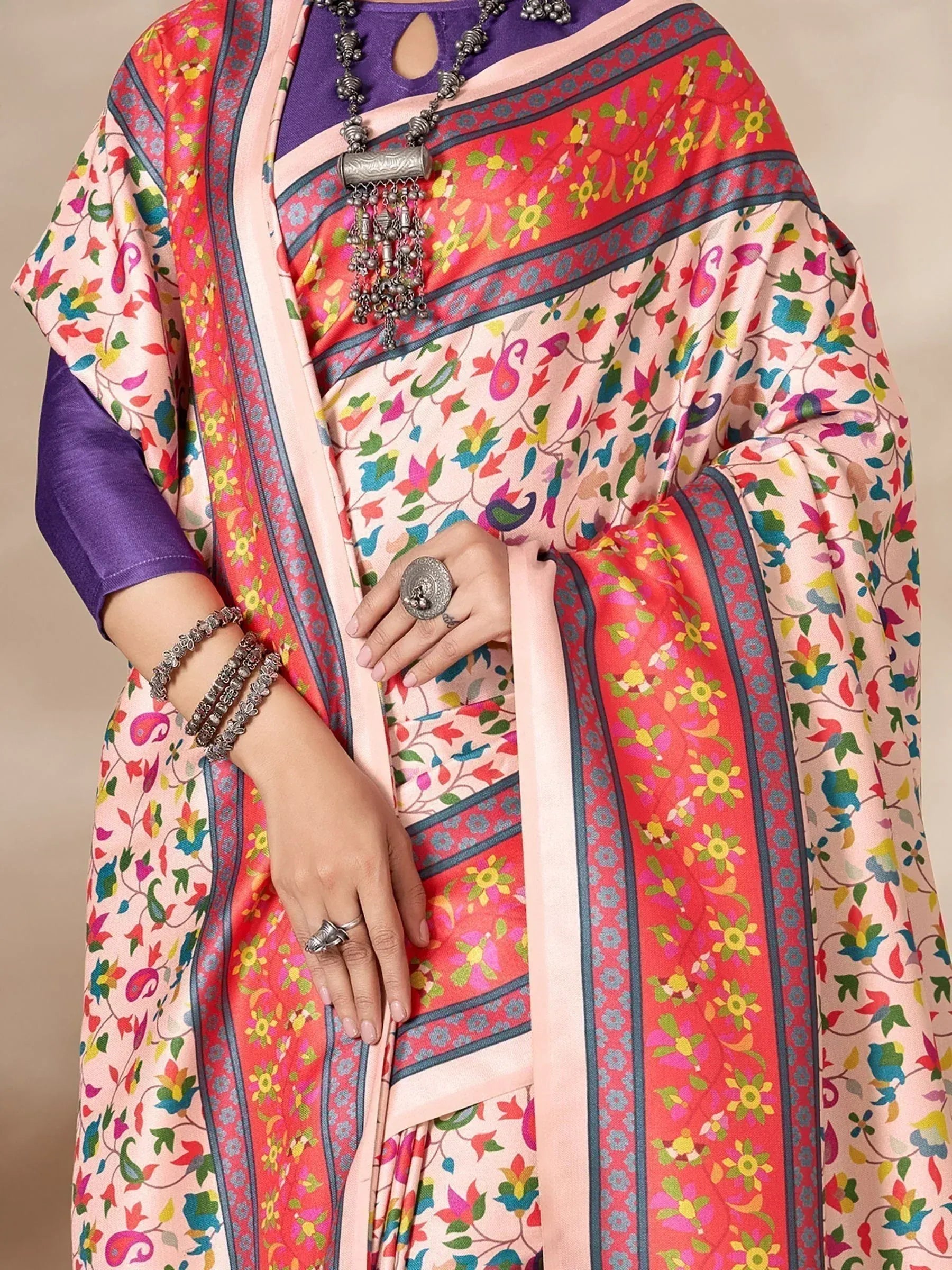 Colorful floral saree with purple blouse, ethnic jewelry, and paisley print for Indian occasions