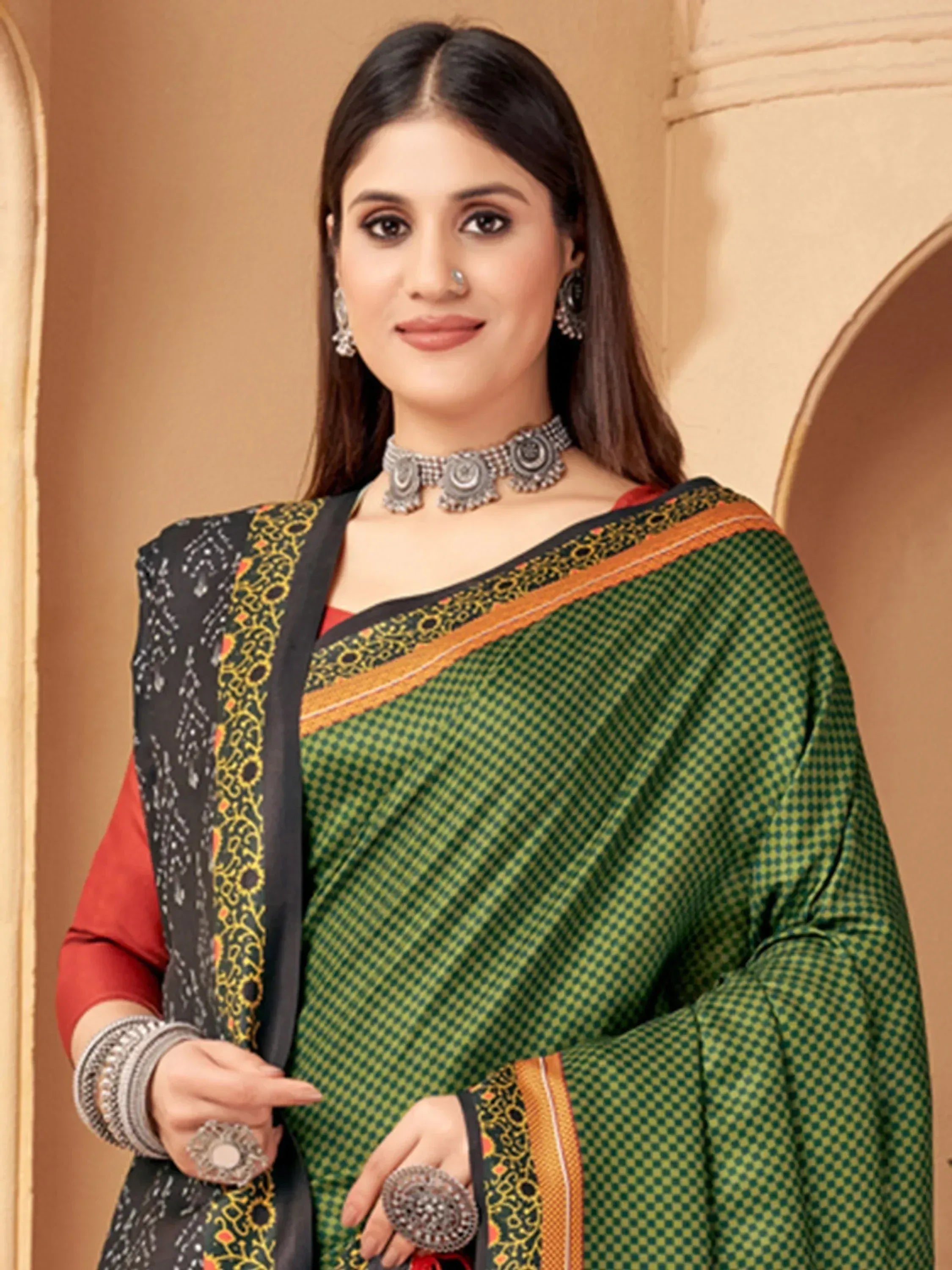 Woman in green checkered saree with black border, red blouse, and ethnic jewelry for Indian ethnic wear