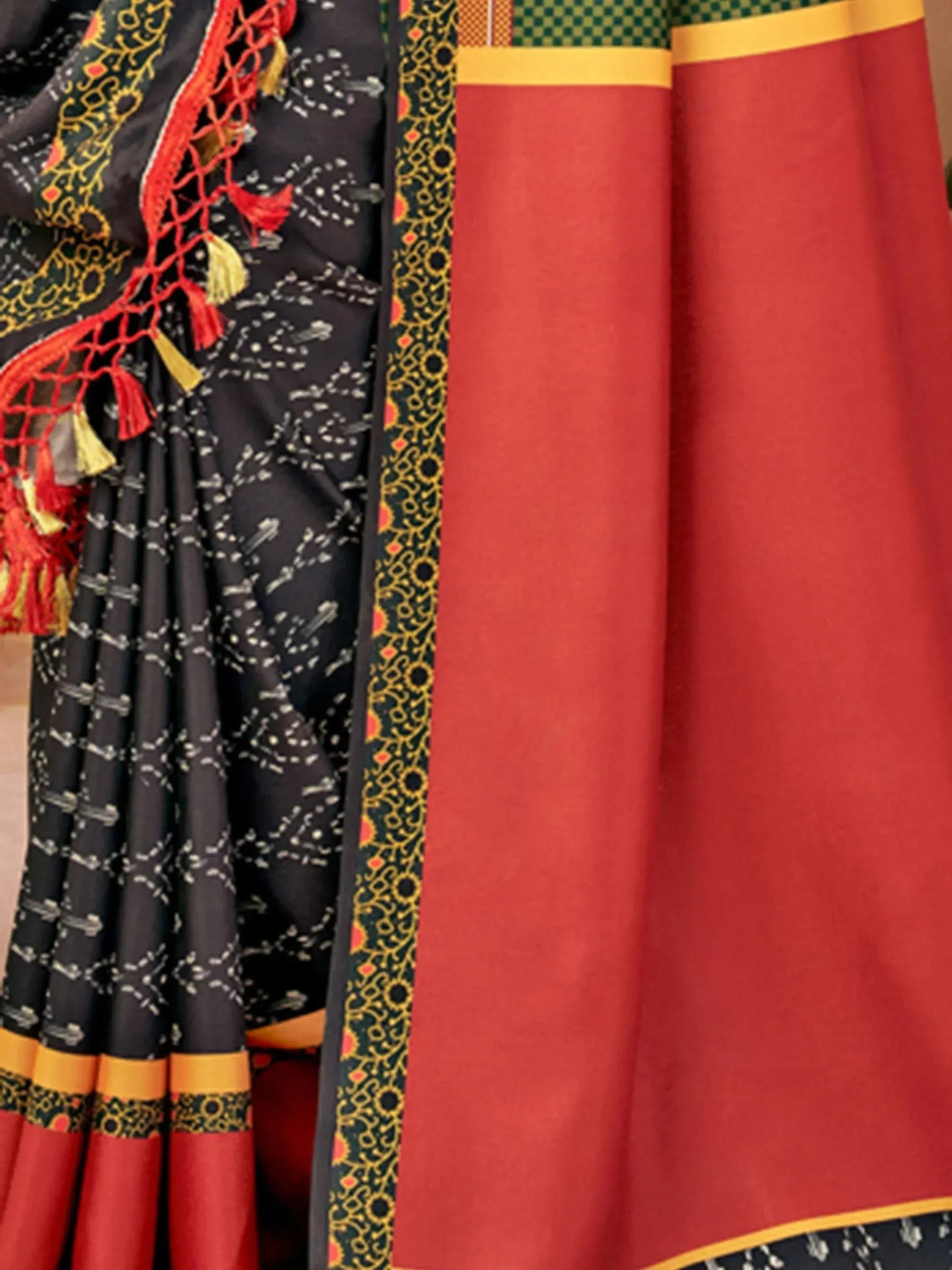 Black and red ethnic saree with gold border and tassel details, traditional Indian wear