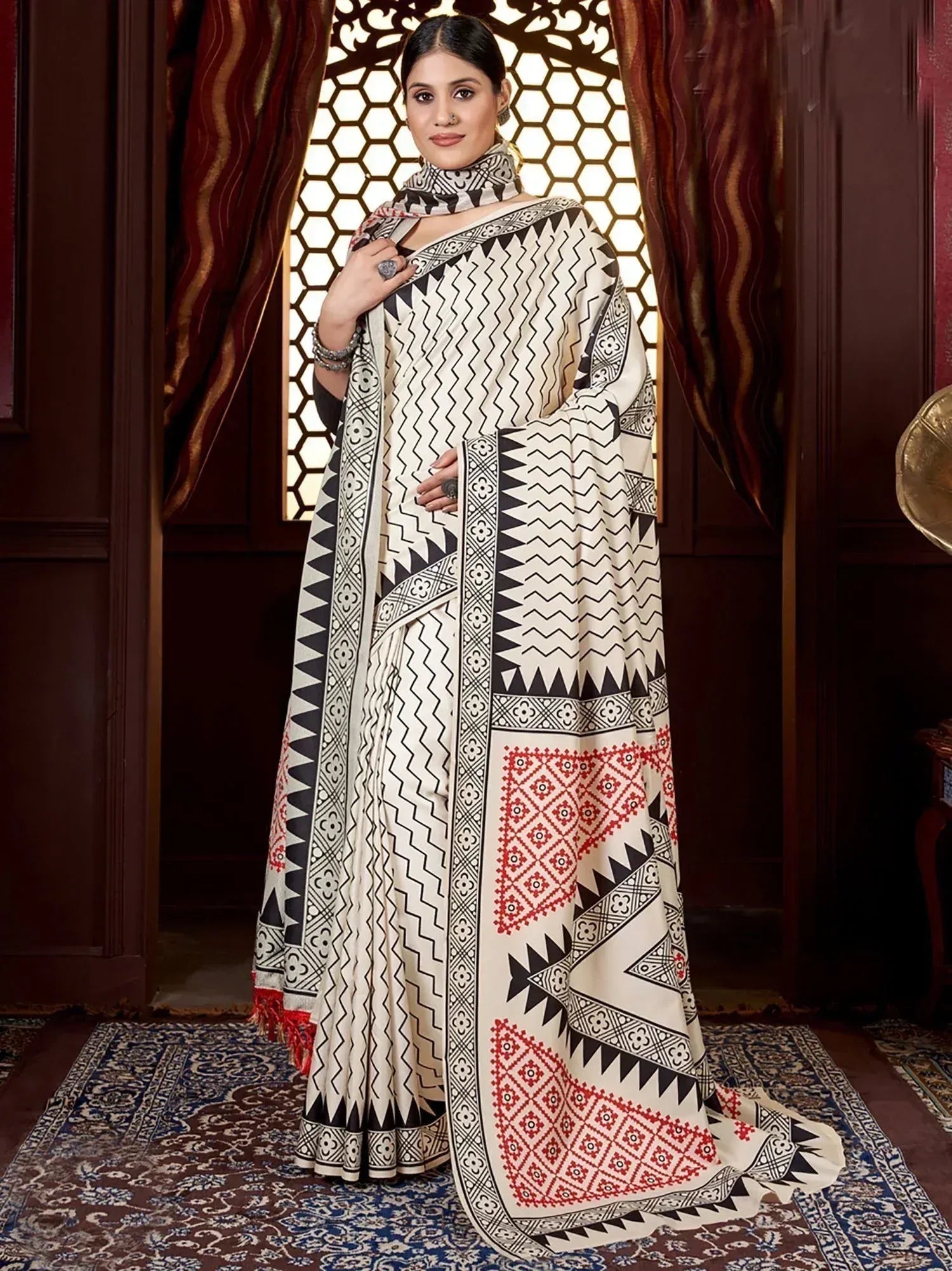 Woman in elegant ethnic saree with black, white, and red geometric print, perfect for Indian occasions