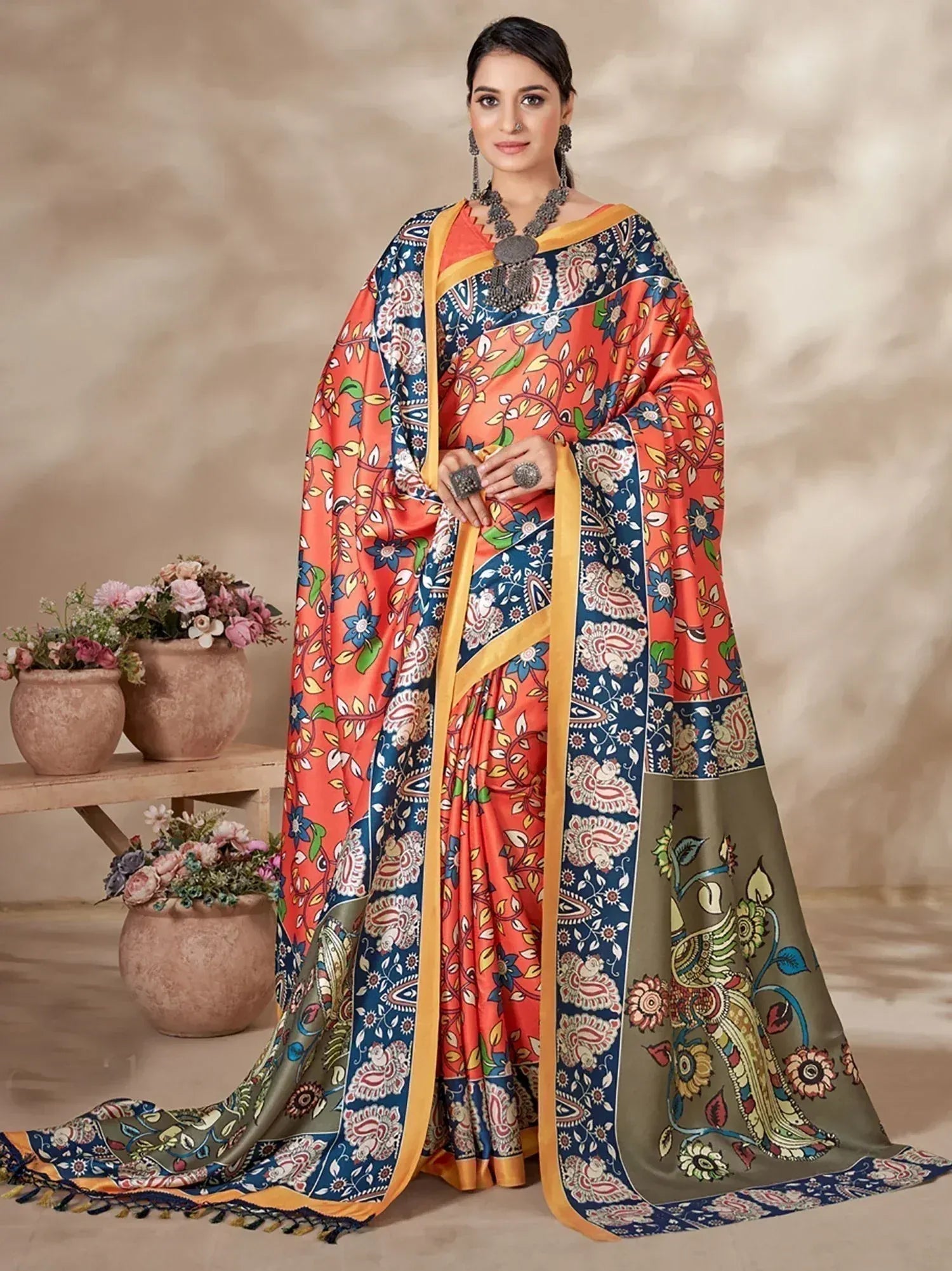 Vibrant floral print saree with orange, blue, and green hues, perfect for Indian ethnic wear occasions