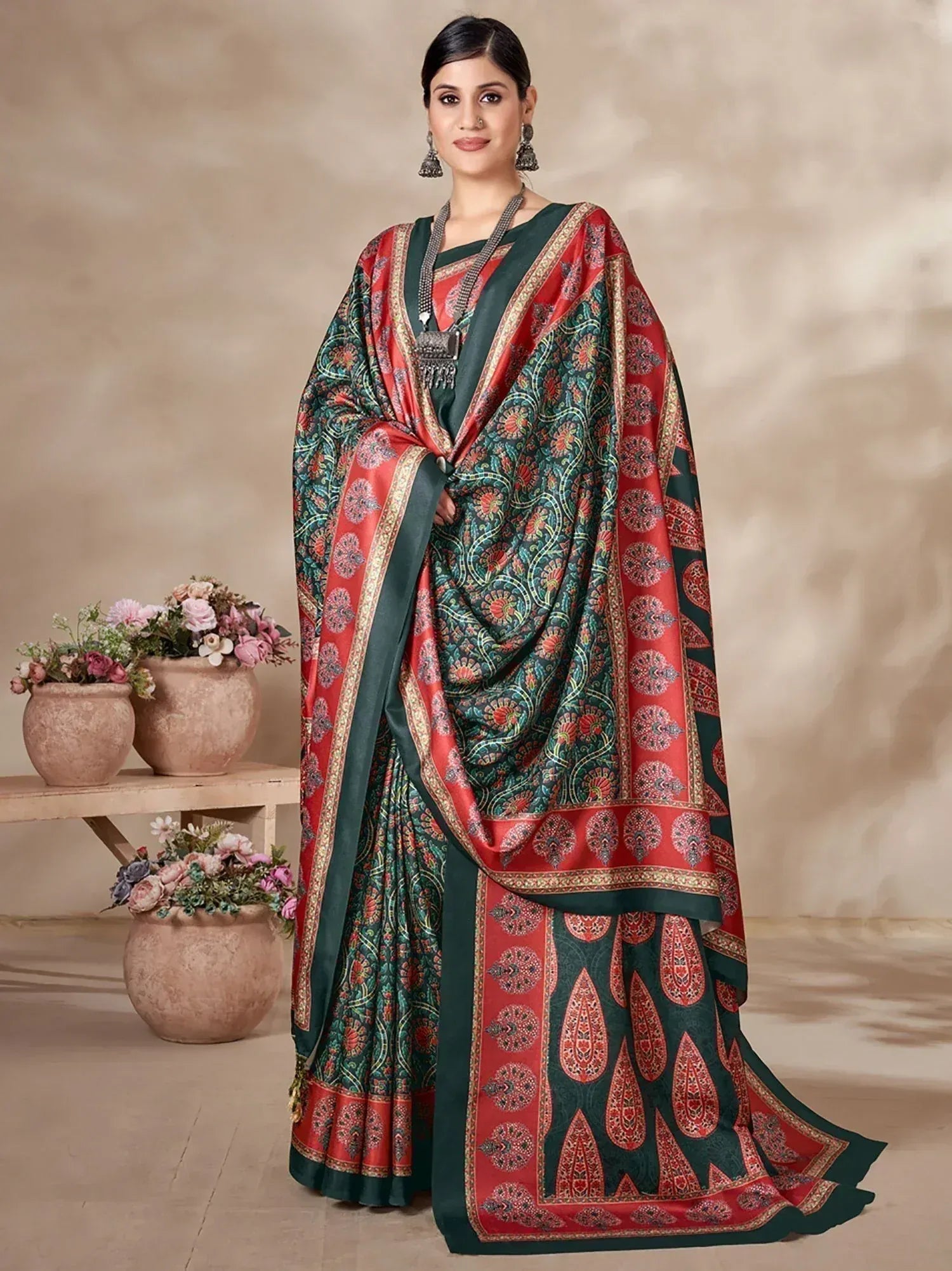 Woman in red and green printed saree with paisley design, ethnic Indian wear for festive occasions