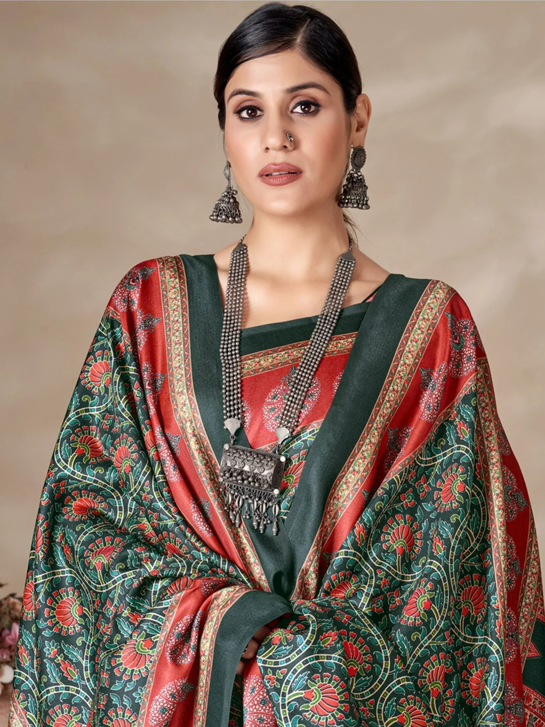 Woman in green and red floral printed ethnic saree with traditional jewelry