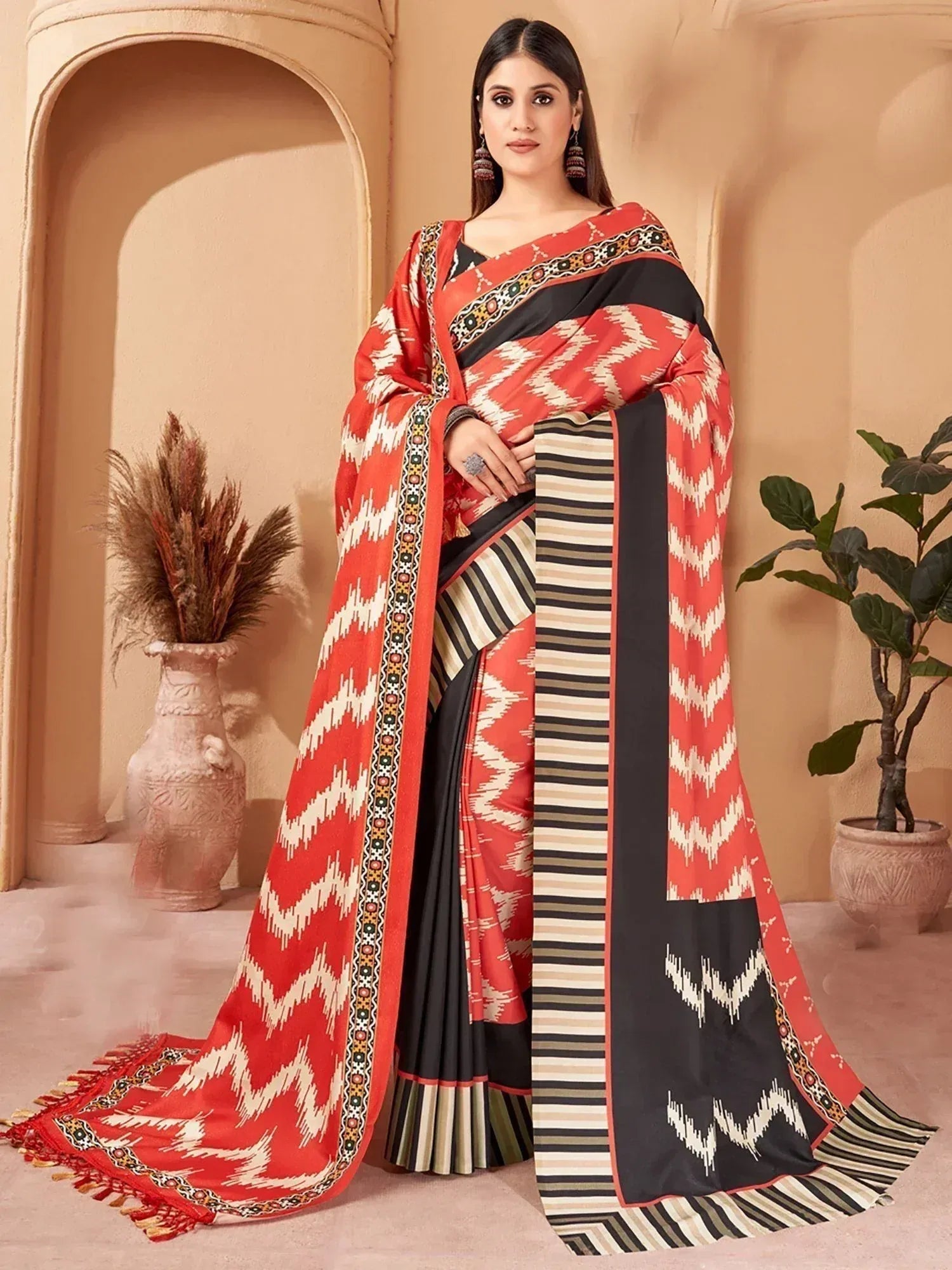 Red and black ethnic saree with ikat zigzag print and striped border, perfect for Indian occasions