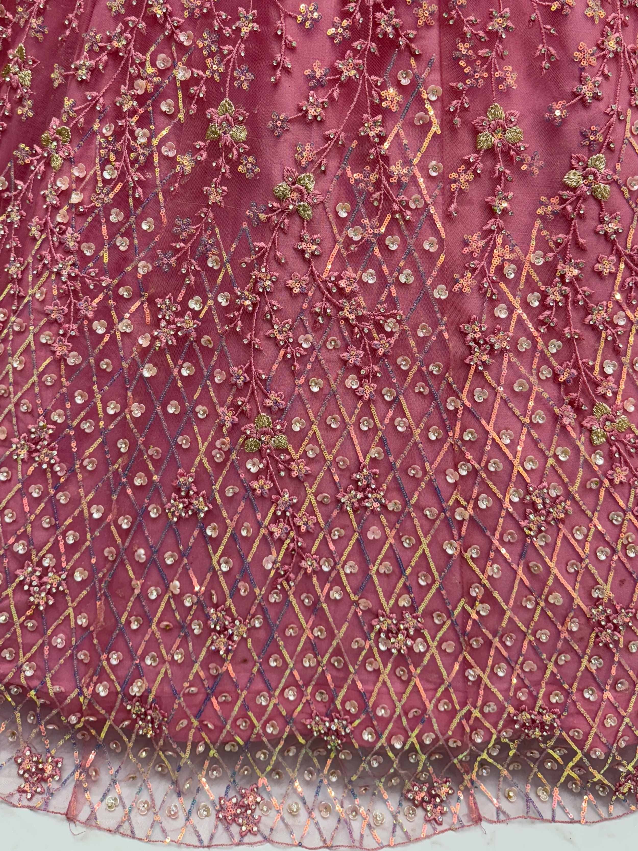 Pink ethnic wear fabric with floral embroidery, sequins, and diamond patterns for lehenga or saree
