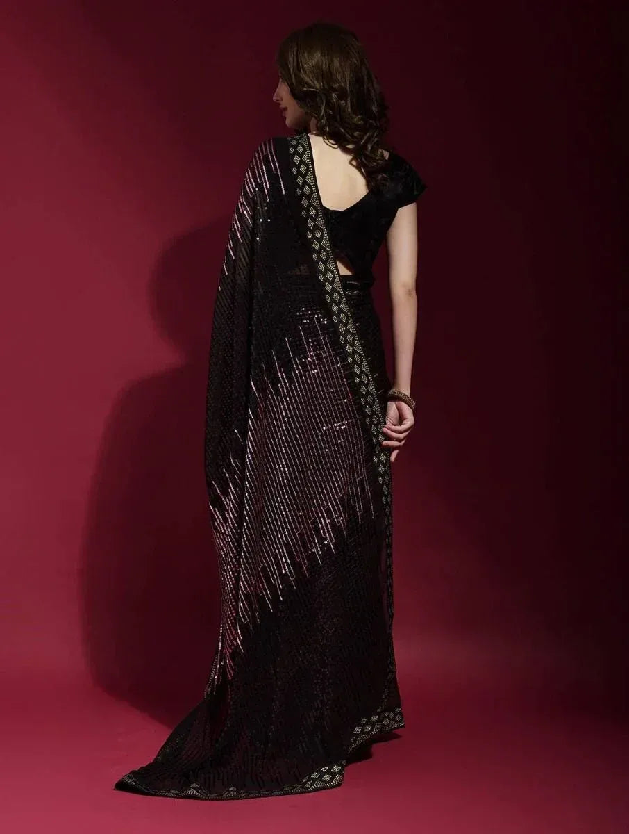 Black sequined saree with geometric border, styled with backless blouse for ethnic occasions
