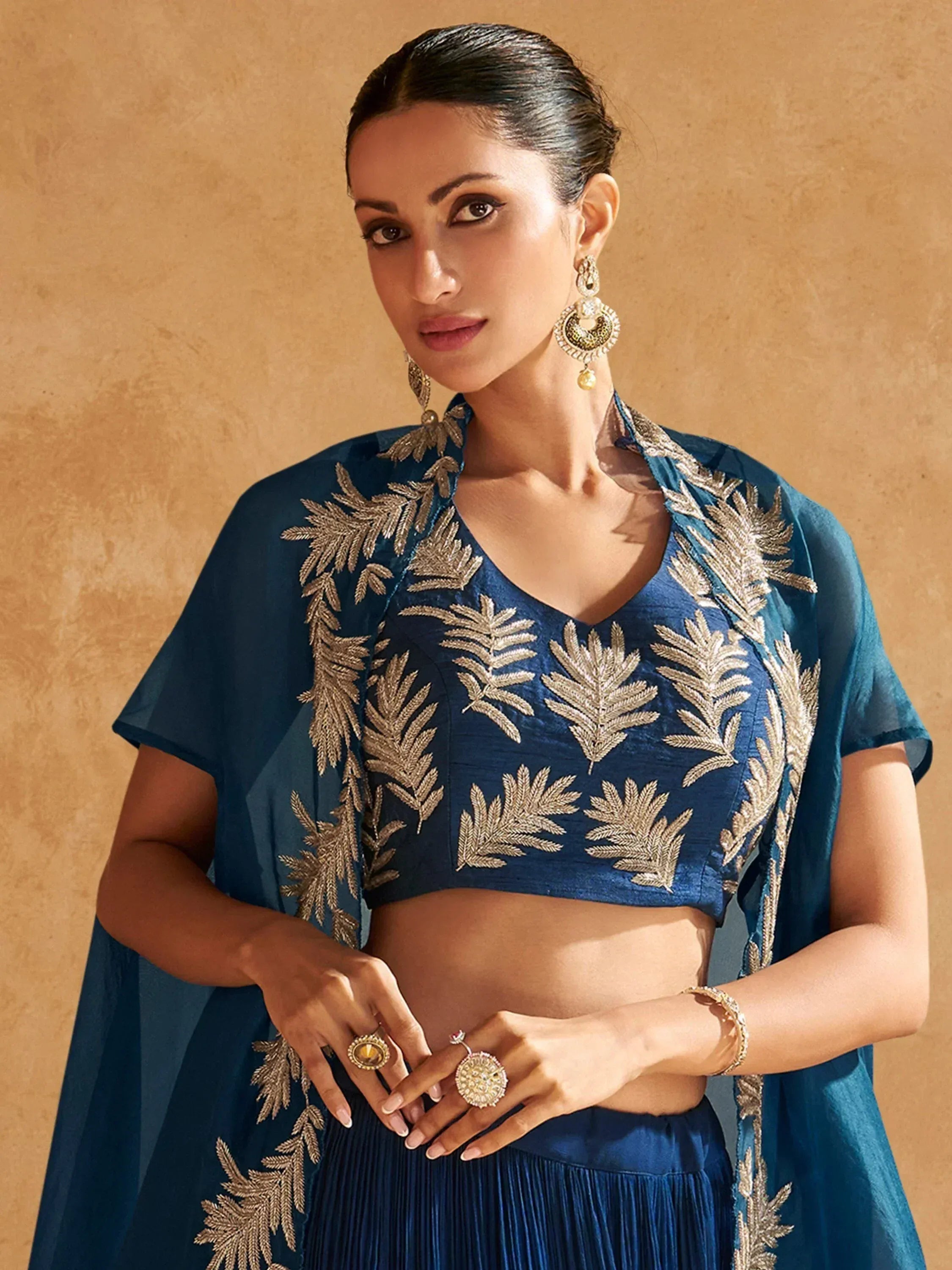 Blue embroidered lehenga choli with gold leaf detailing, perfect for Indian ethnic wear occasions