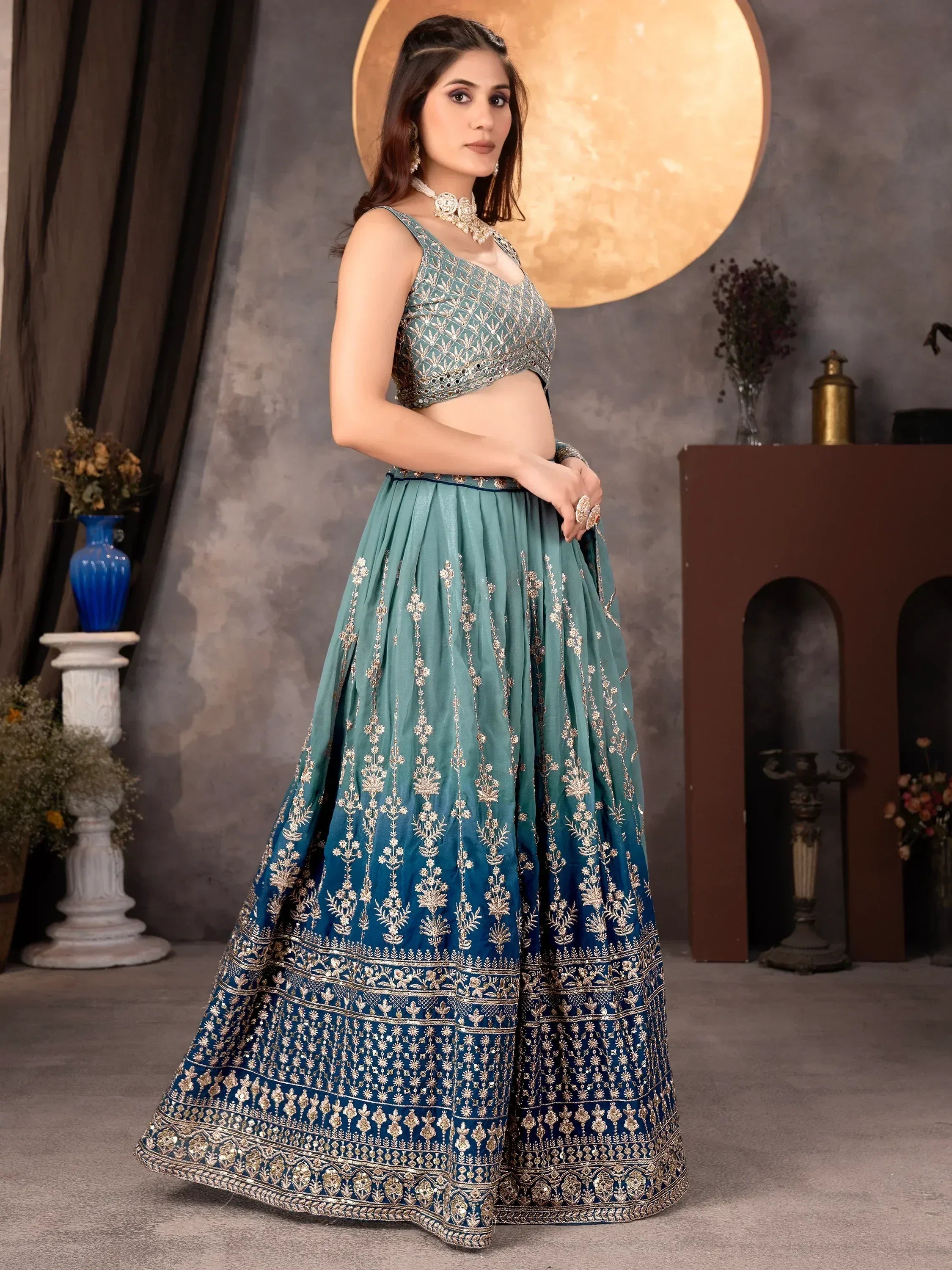 Teal blue embroidered lehenga choli with gold detailing, perfect for Indian ethnic wear events