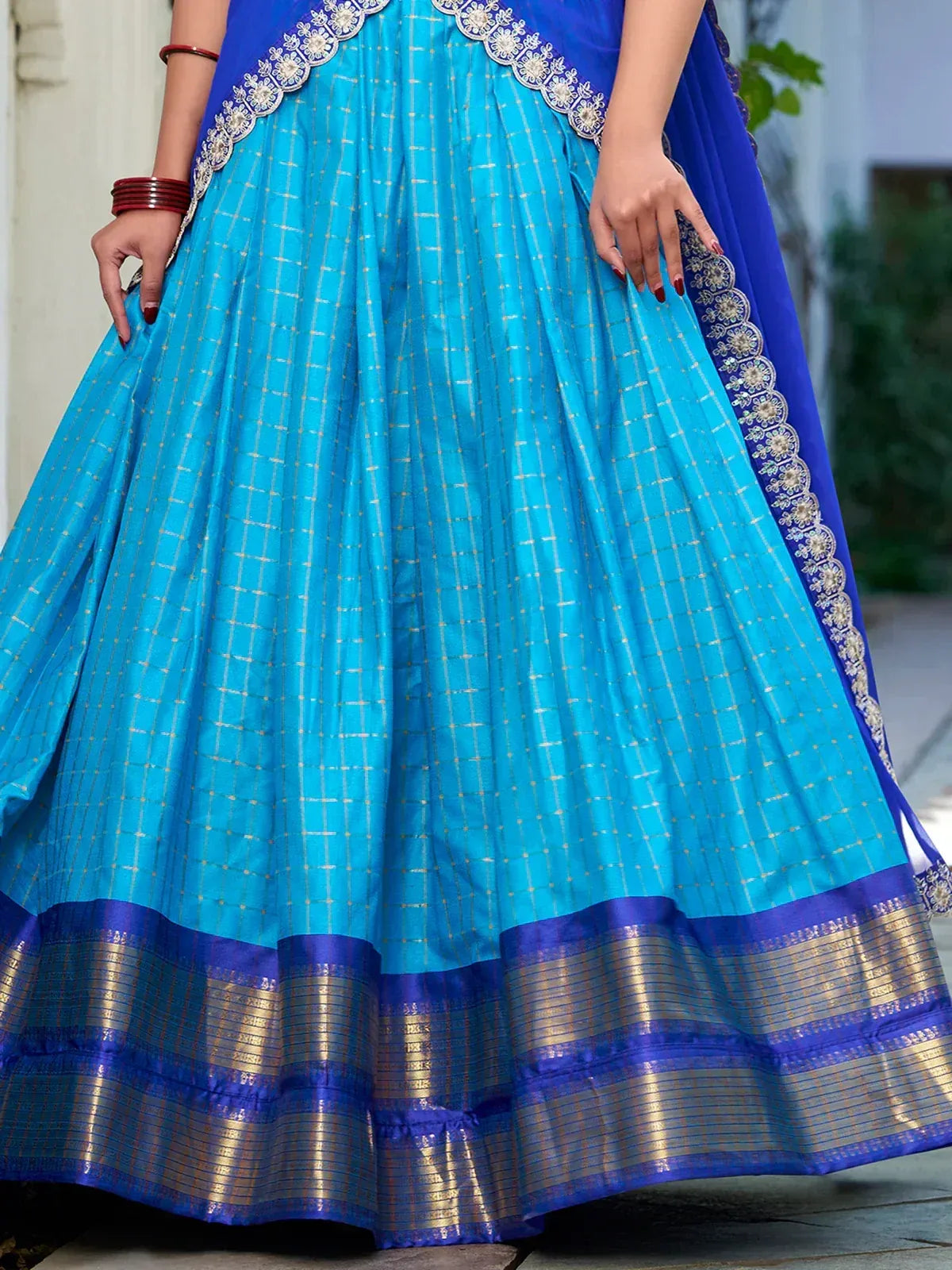 Blue ethnic lehenga with golden checks and embroidered border, perfect for festive occasions