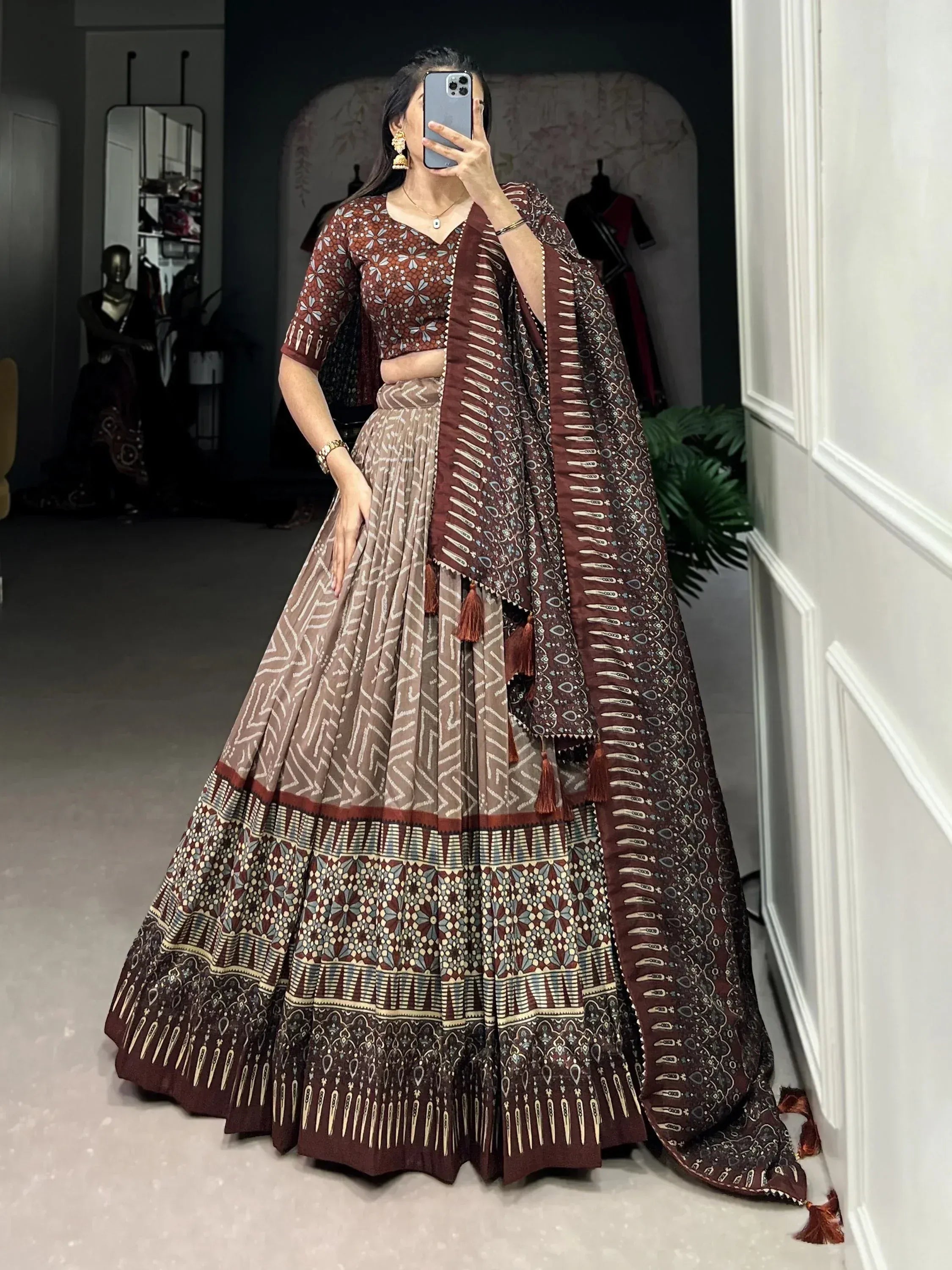 Woman in printed lehenga choli with dupatta, ethnic Indian wear for festive occasions