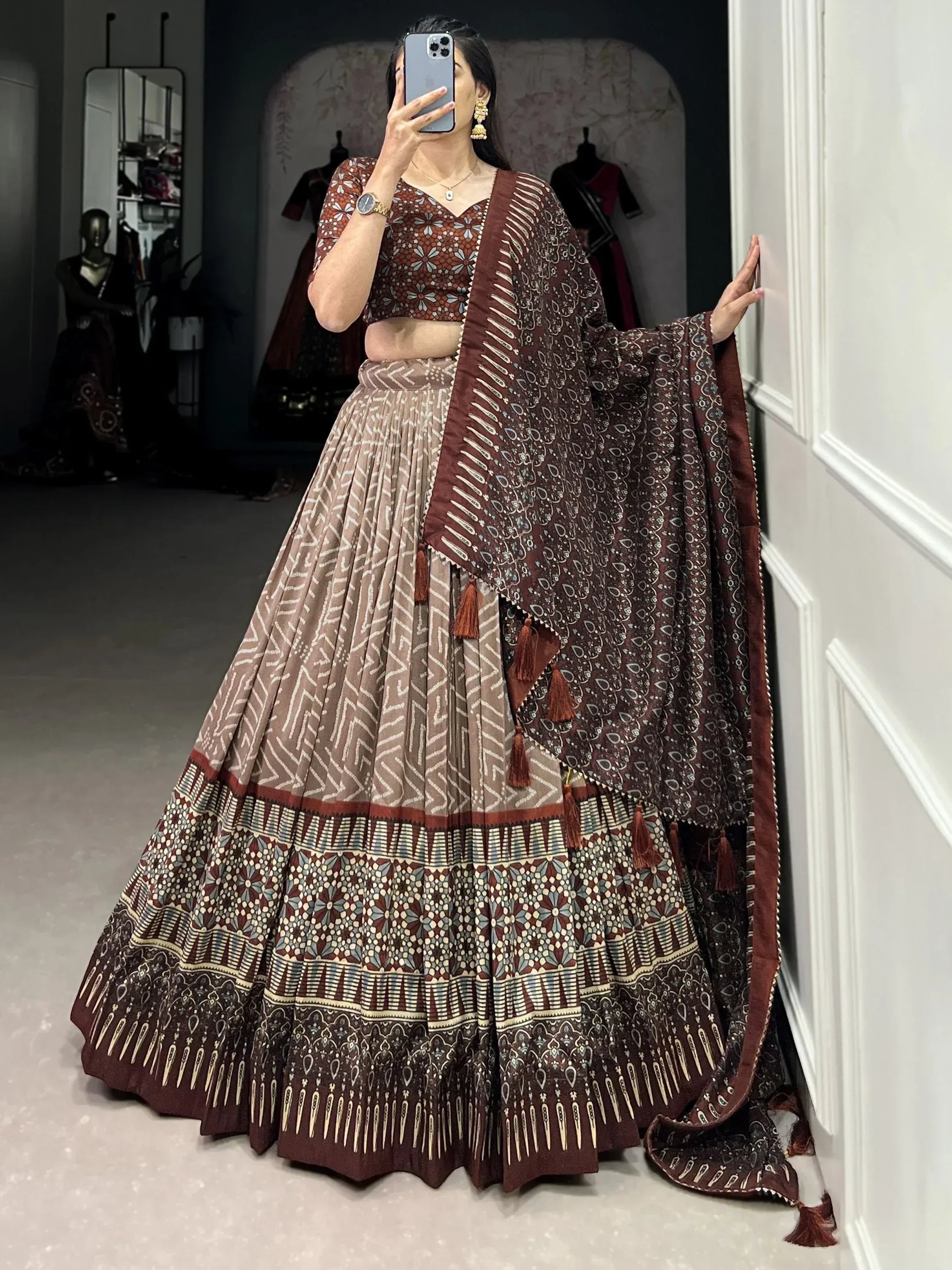 Woman in maroon and beige printed lehenga choli with tassel dupatta, ethnic Indian wear