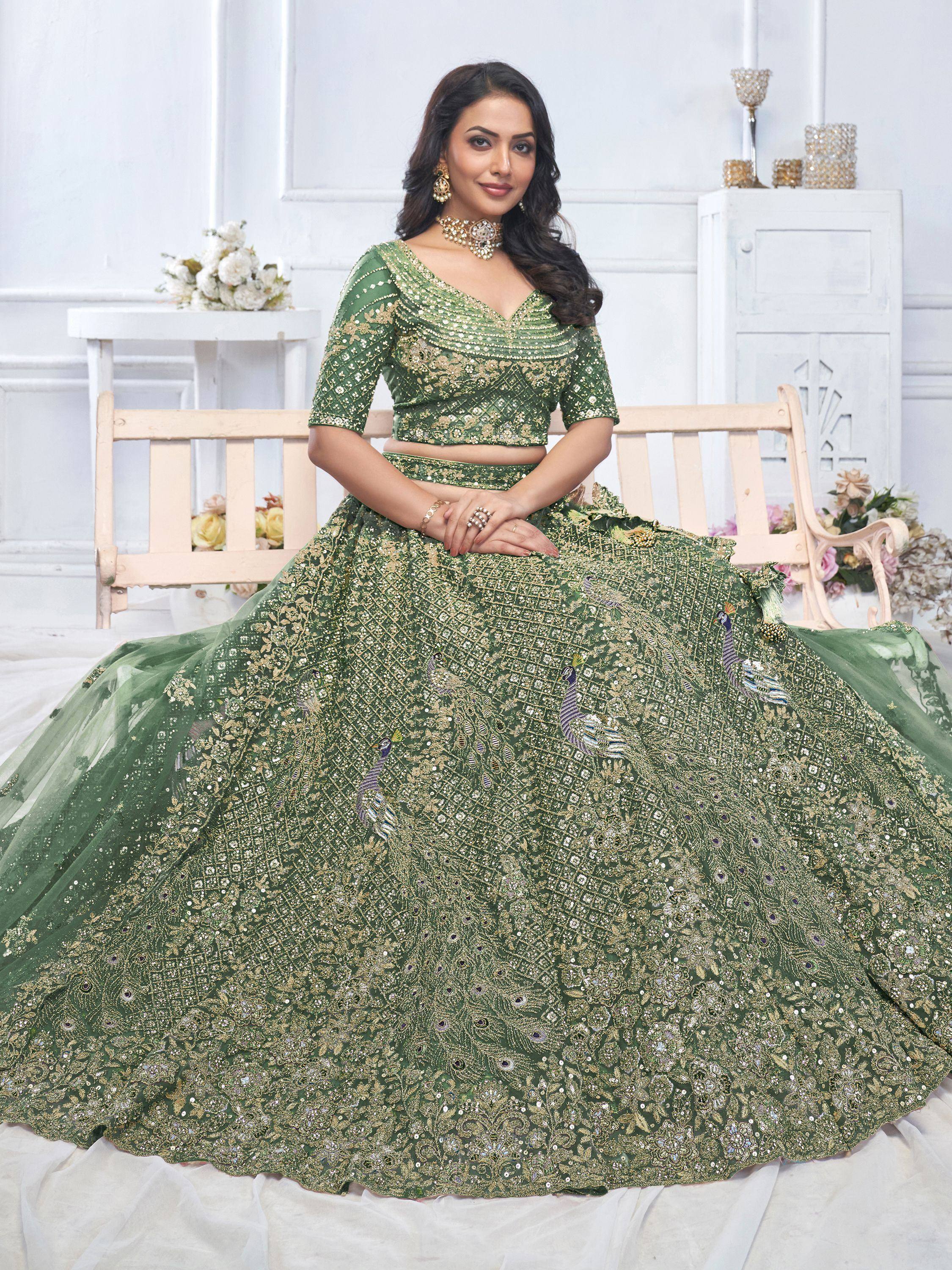 Emerald green designer lehenga choli with peacock embroidery and gold sequins, perfect for weddings and festive occasions.