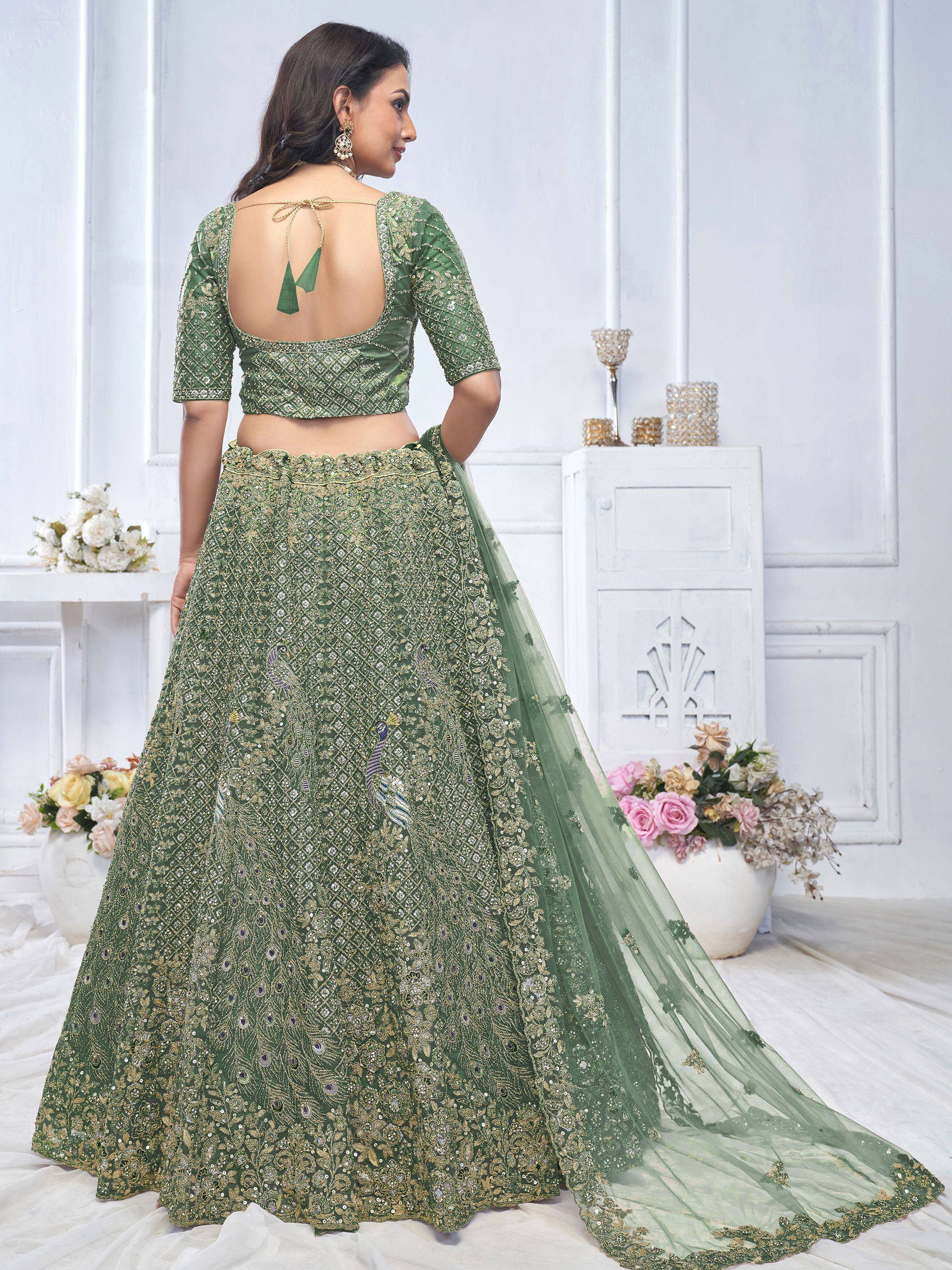 Green embroidered lehenga choli with peacock motifs and back tie blouse, perfect for Indian weddings and festive occasions.