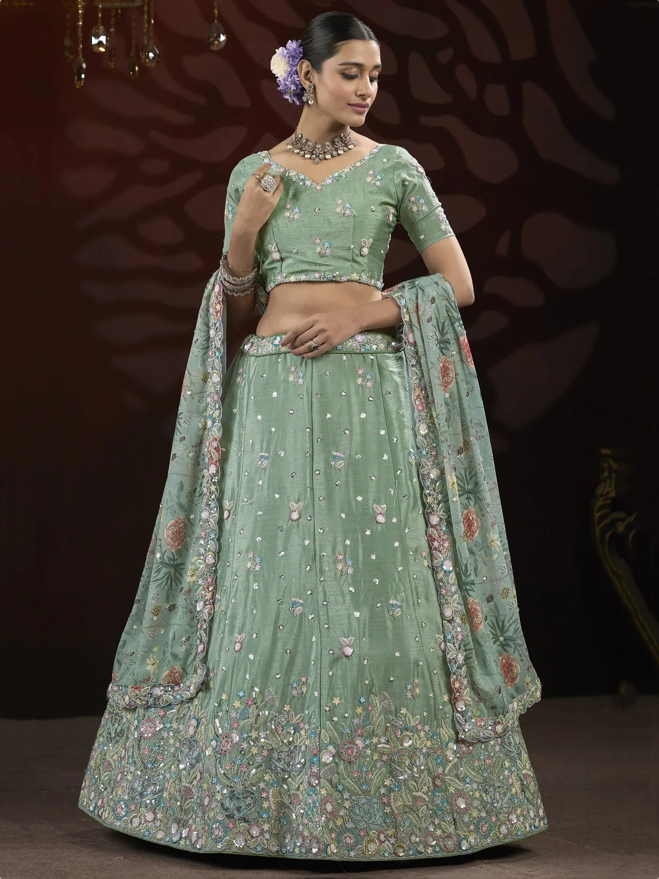 Mint green designer lehenga choli with floral embroidery and sequins, perfect for weddings and parties.