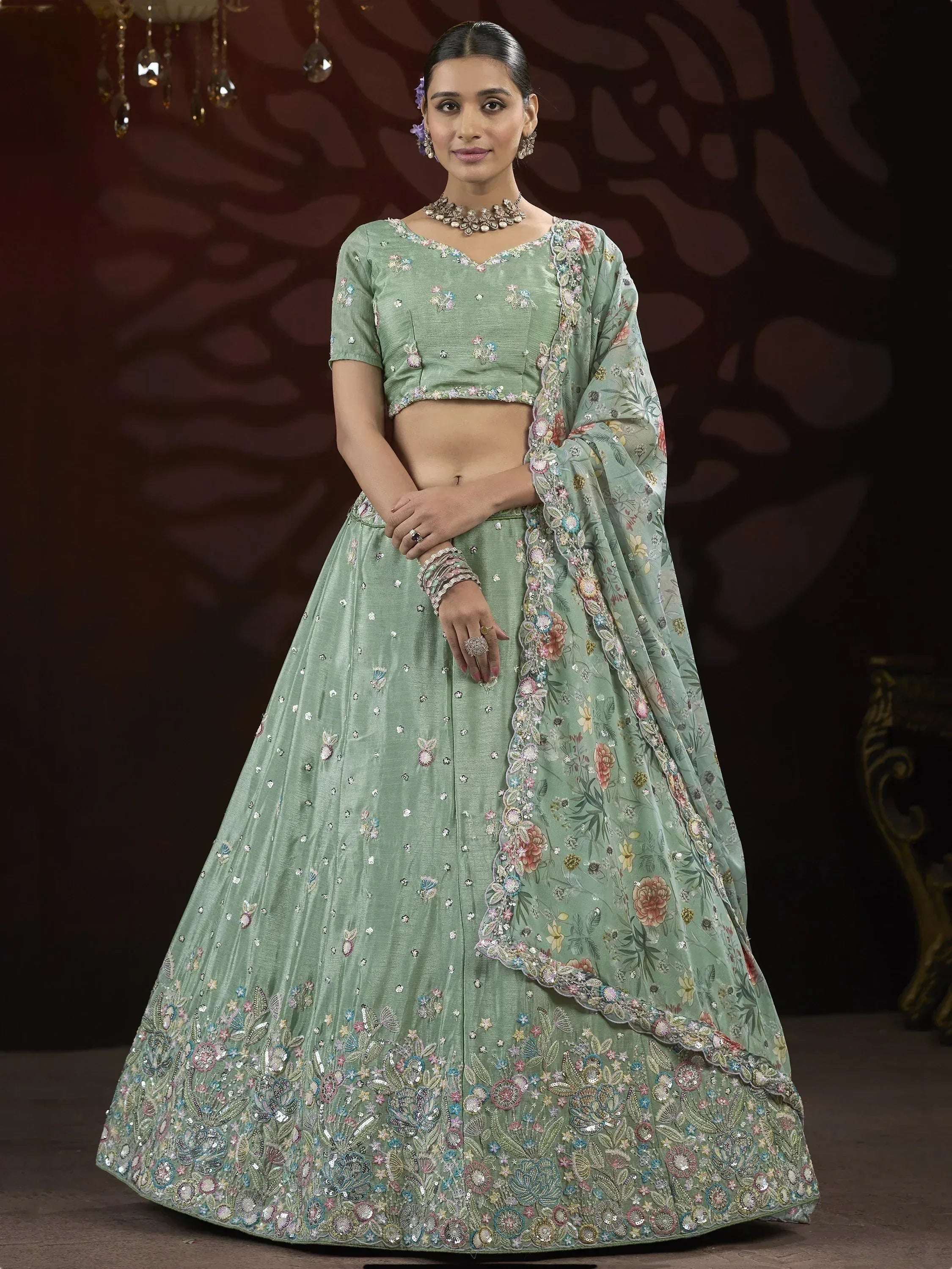 Mint green designer lehenga choli with floral embroidery and sequin work, perfect for Indian weddings and festive occasions.