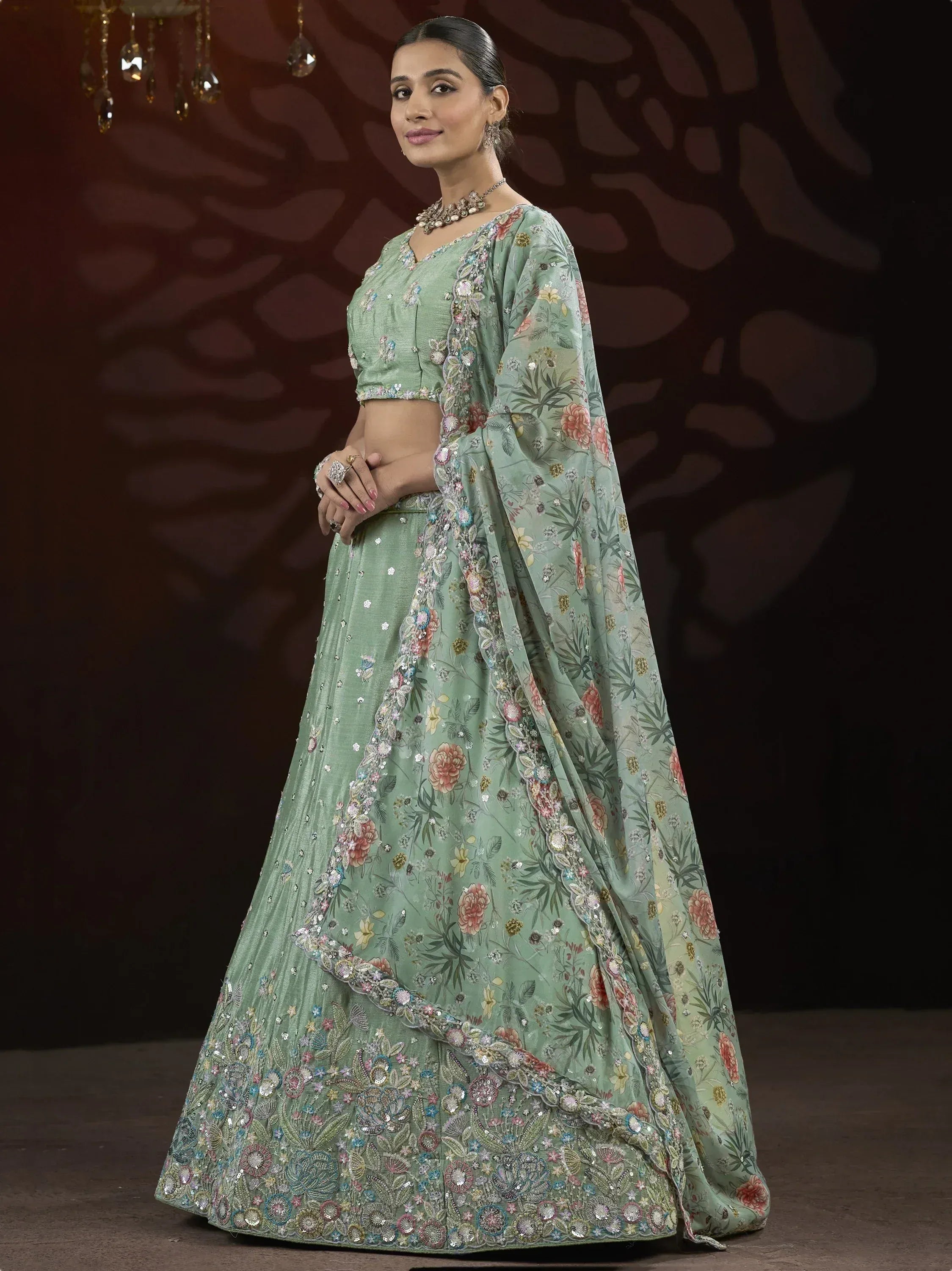 Mint green floral lehenga choli with heavy embroidery and sequins, perfect for Indian weddings and festive occasions.