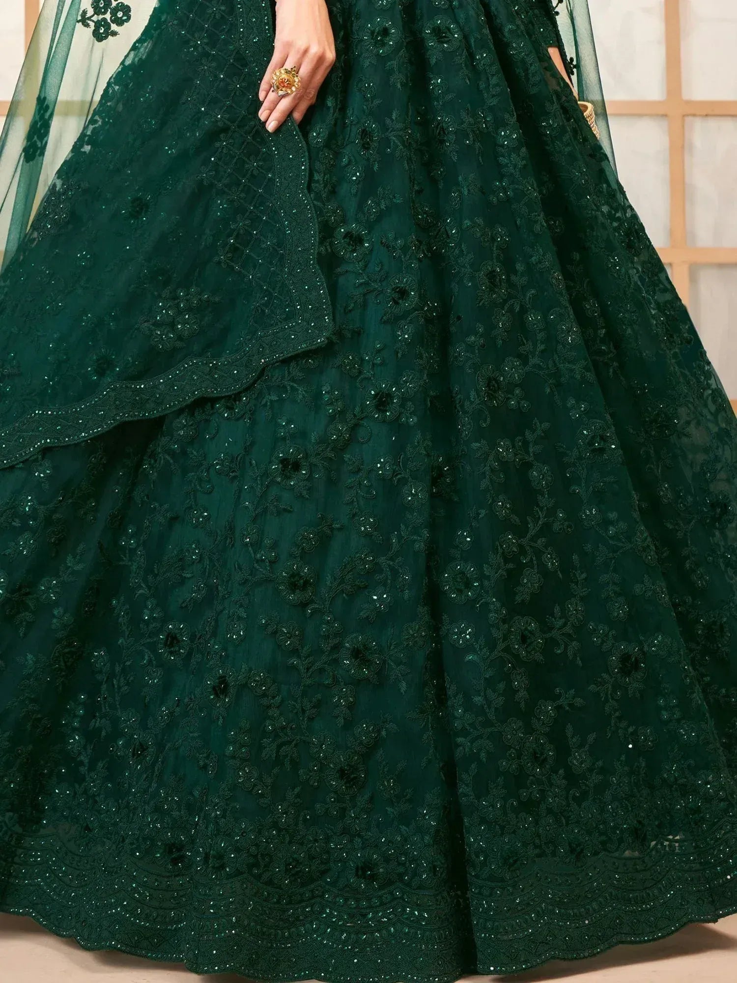 Emerald green designer lehenga with intricate floral embroidery and sequin detailing for Indian ethnic wear