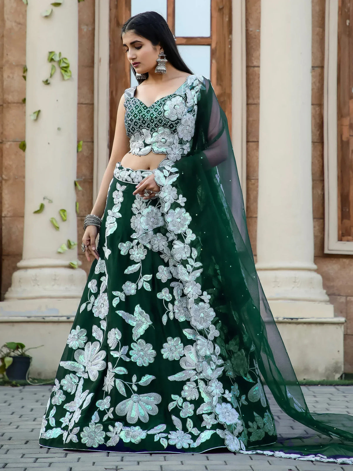 Emerald green lehenga choli with silver floral embroidery, perfect for Indian ethnic occasions.