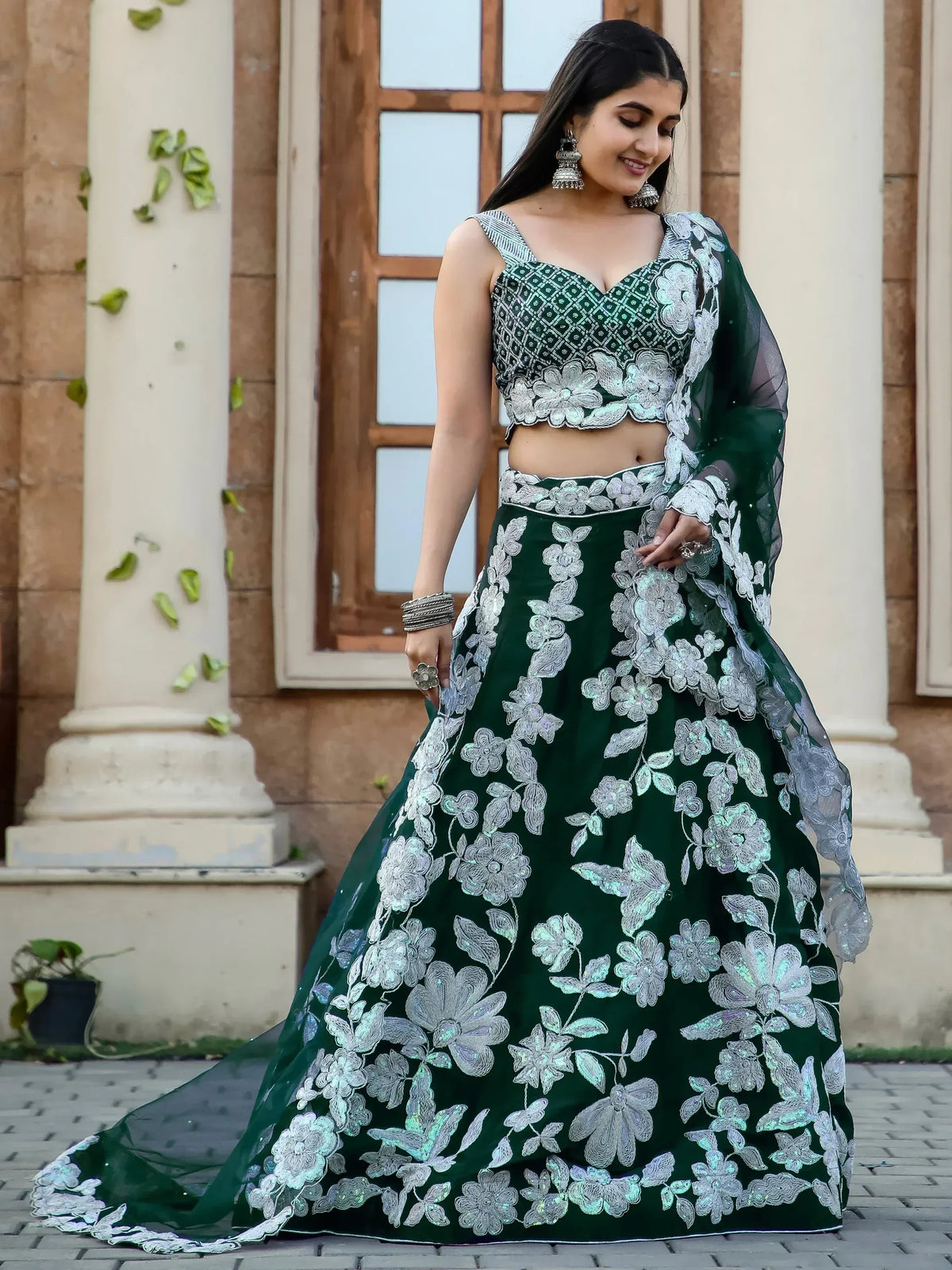 Emerald green lehenga choli with silver floral embroidery, perfect for Indian ethnic occasions