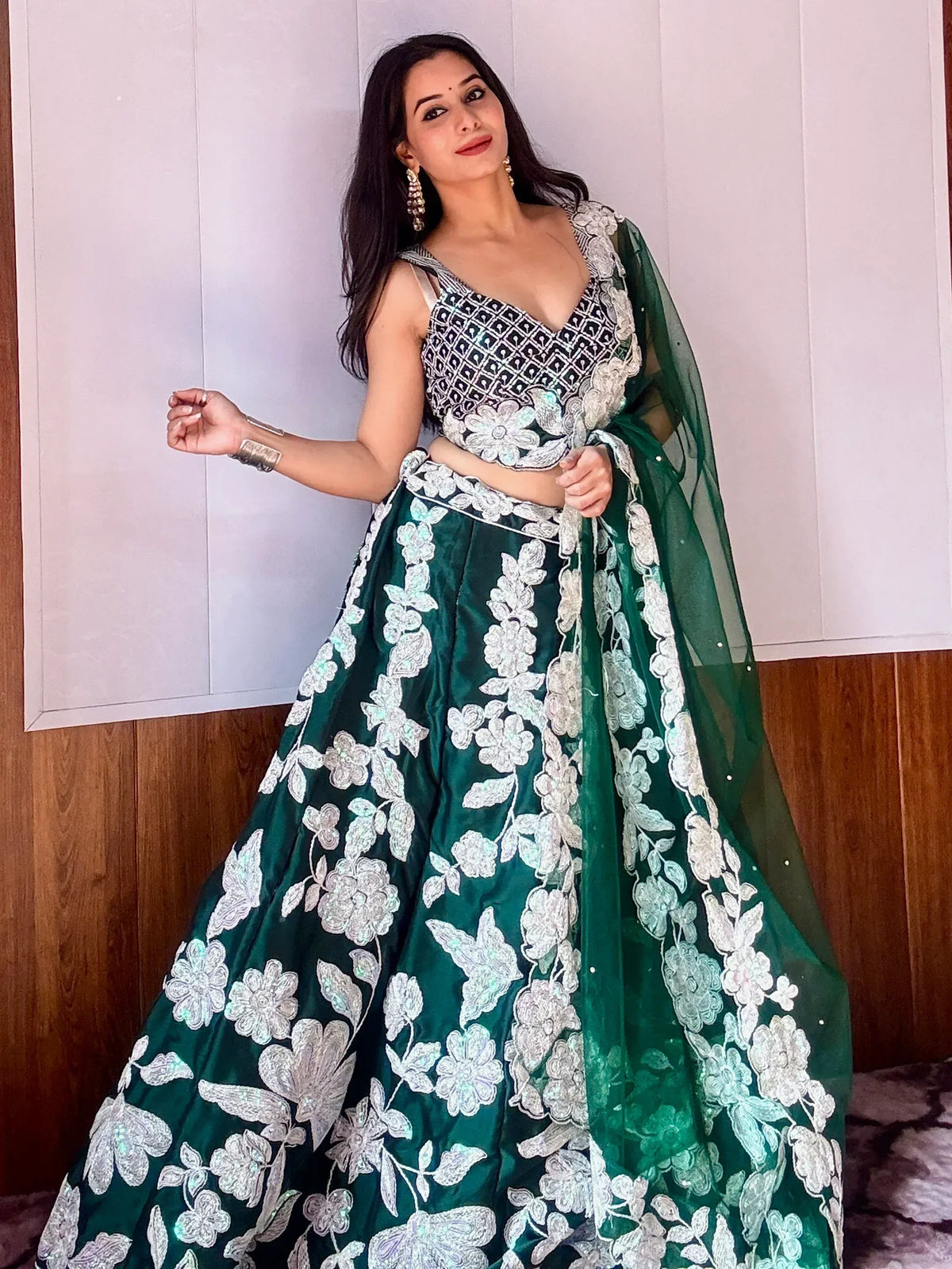 Emerald green lehenga choli with white floral embroidery, perfect for Indian weddings and festive occasions.