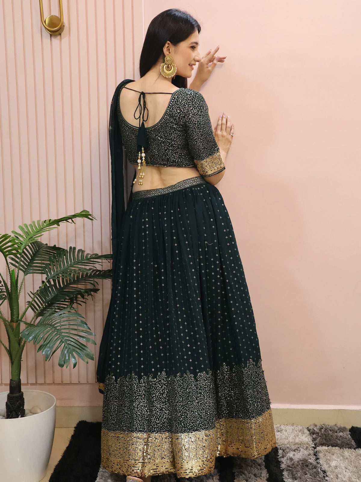 Elegant dark green lehenga choli with gold sequin detailing and back tie blouse, perfect for Indian ethnic wear.
