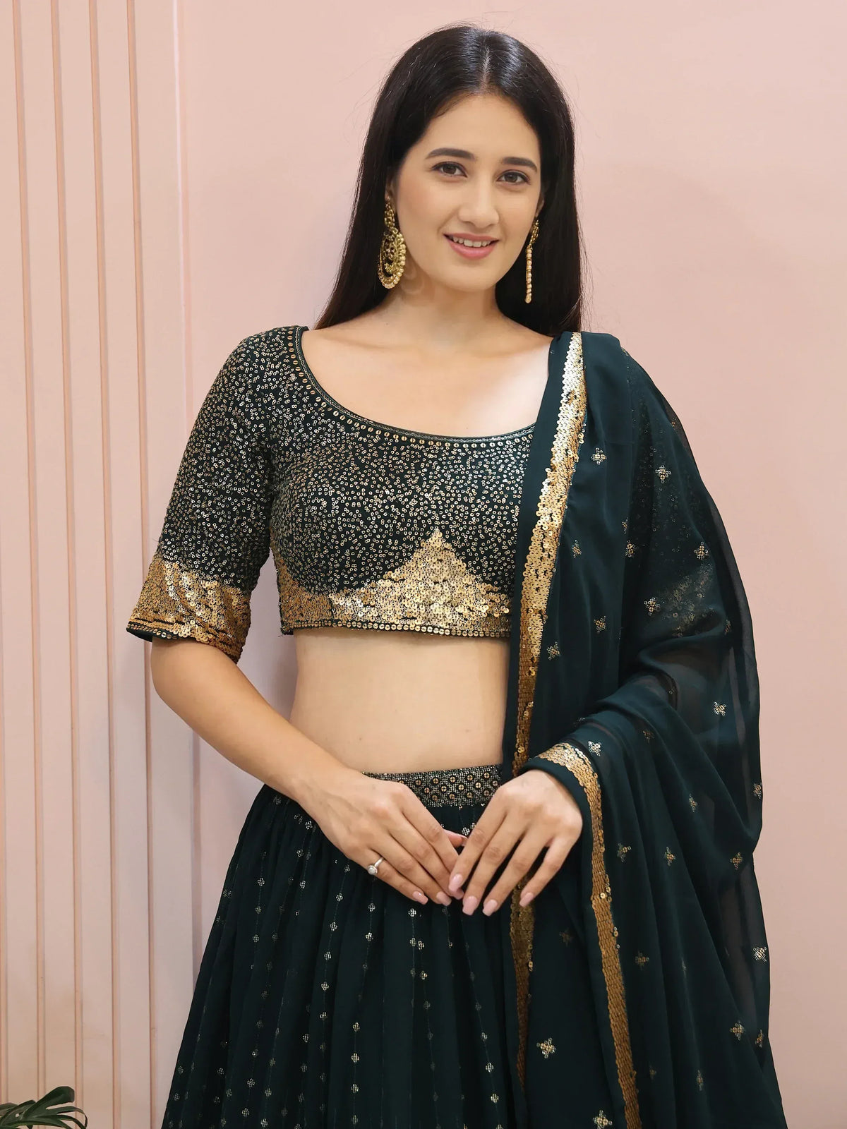 Elegant dark green lehenga choli with gold sequin blouse and dupatta, perfect for Indian ethnic occasions.