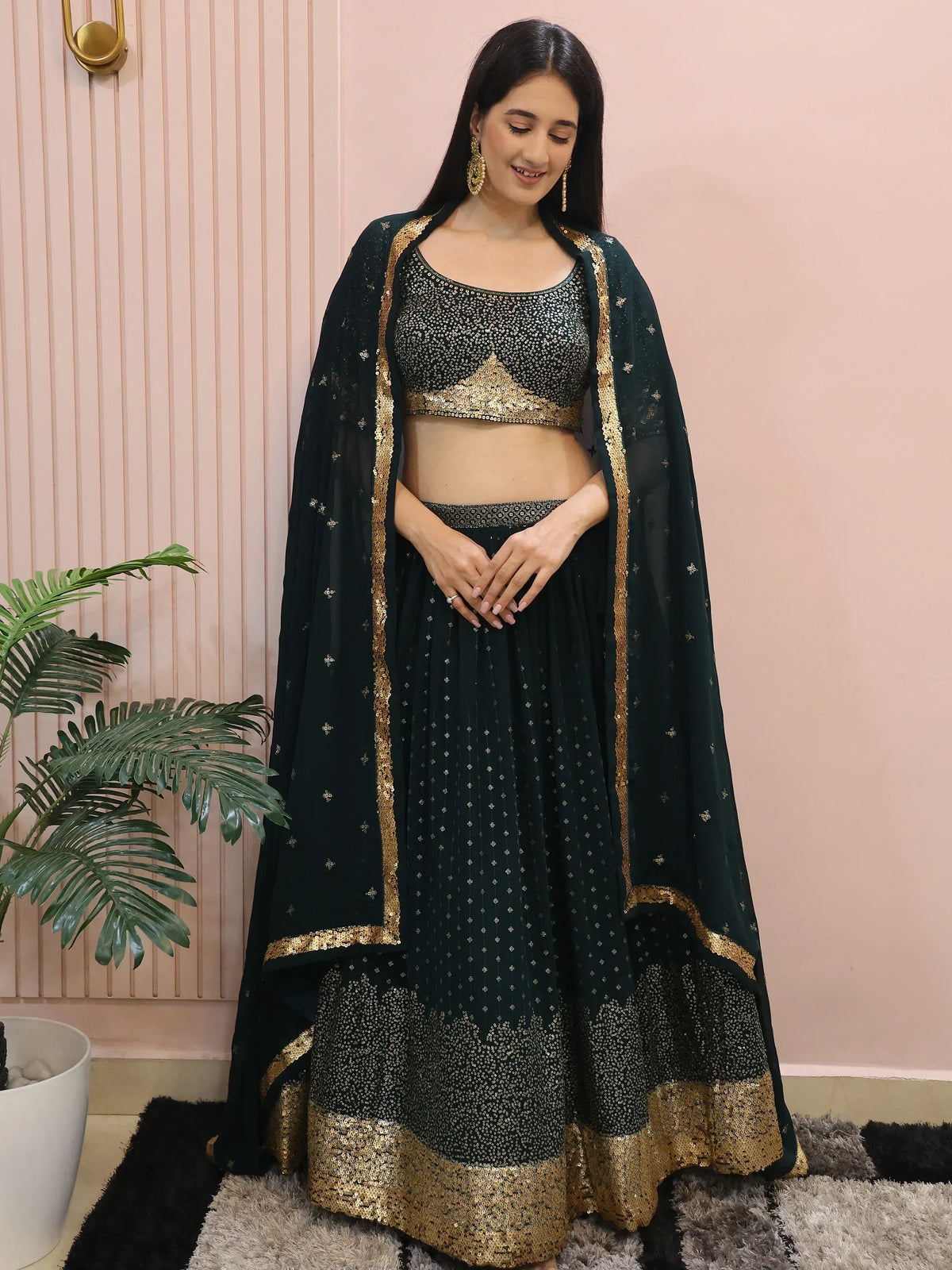 Emerald green lehenga choli with gold sequin work, perfect for Indian ethnic wear and festive occasions.