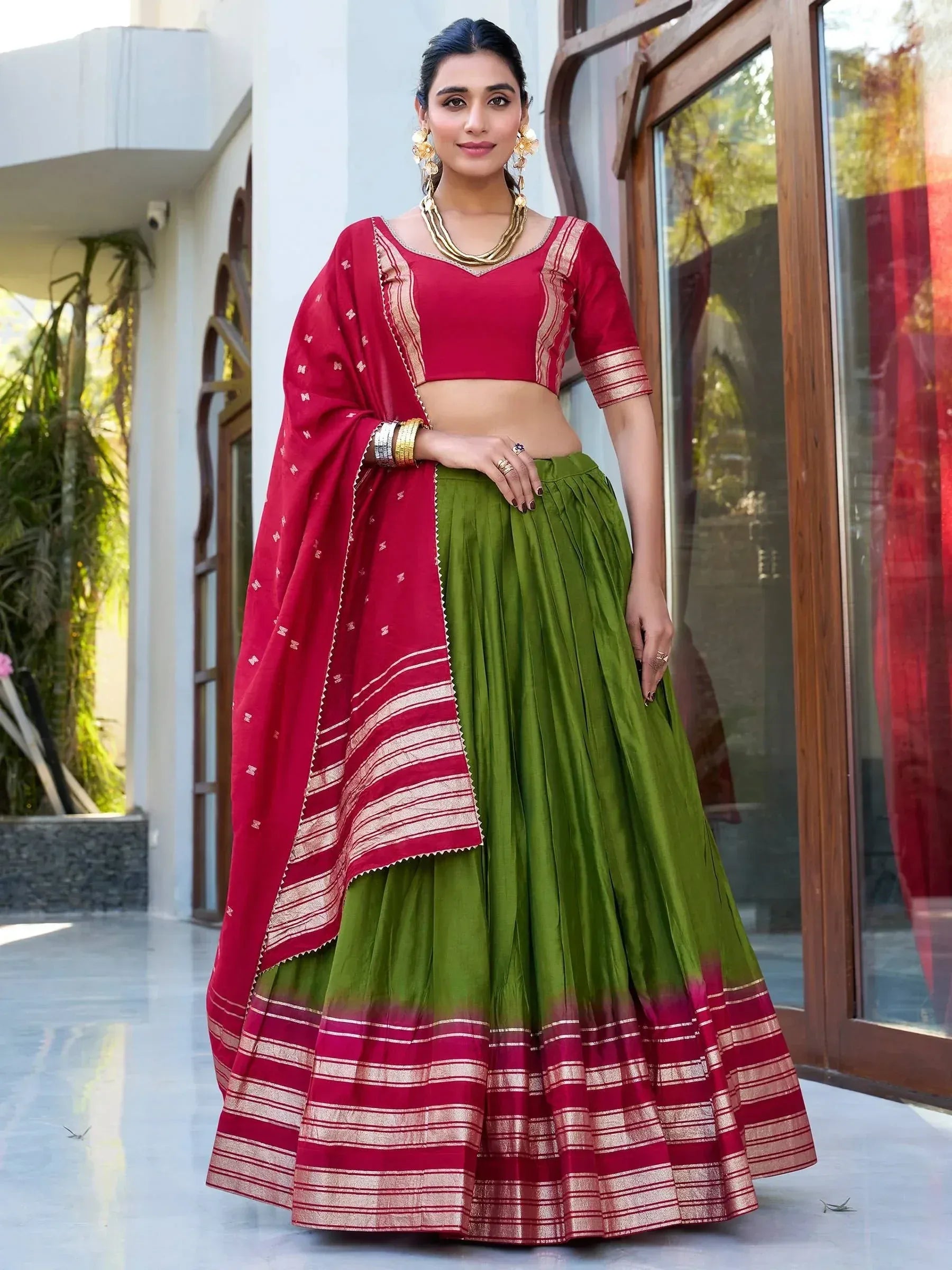 Red and green ethnic lehenga choli with gold trim, perfect for Indian weddings and festivals