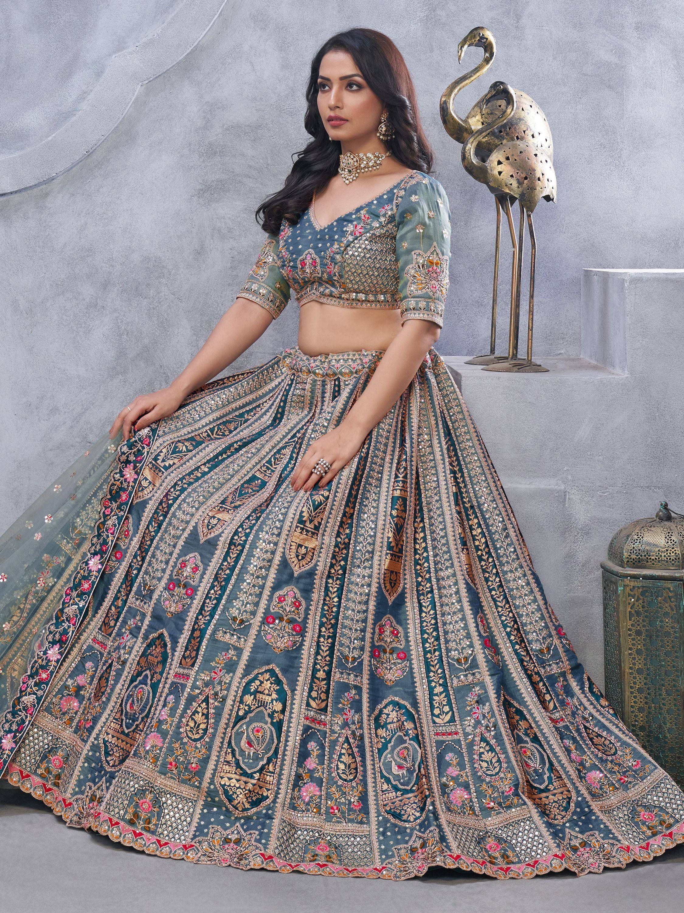 Teal embroidered lehenga choli with gold floral motifs, perfect for Indian weddings and festive occasions.