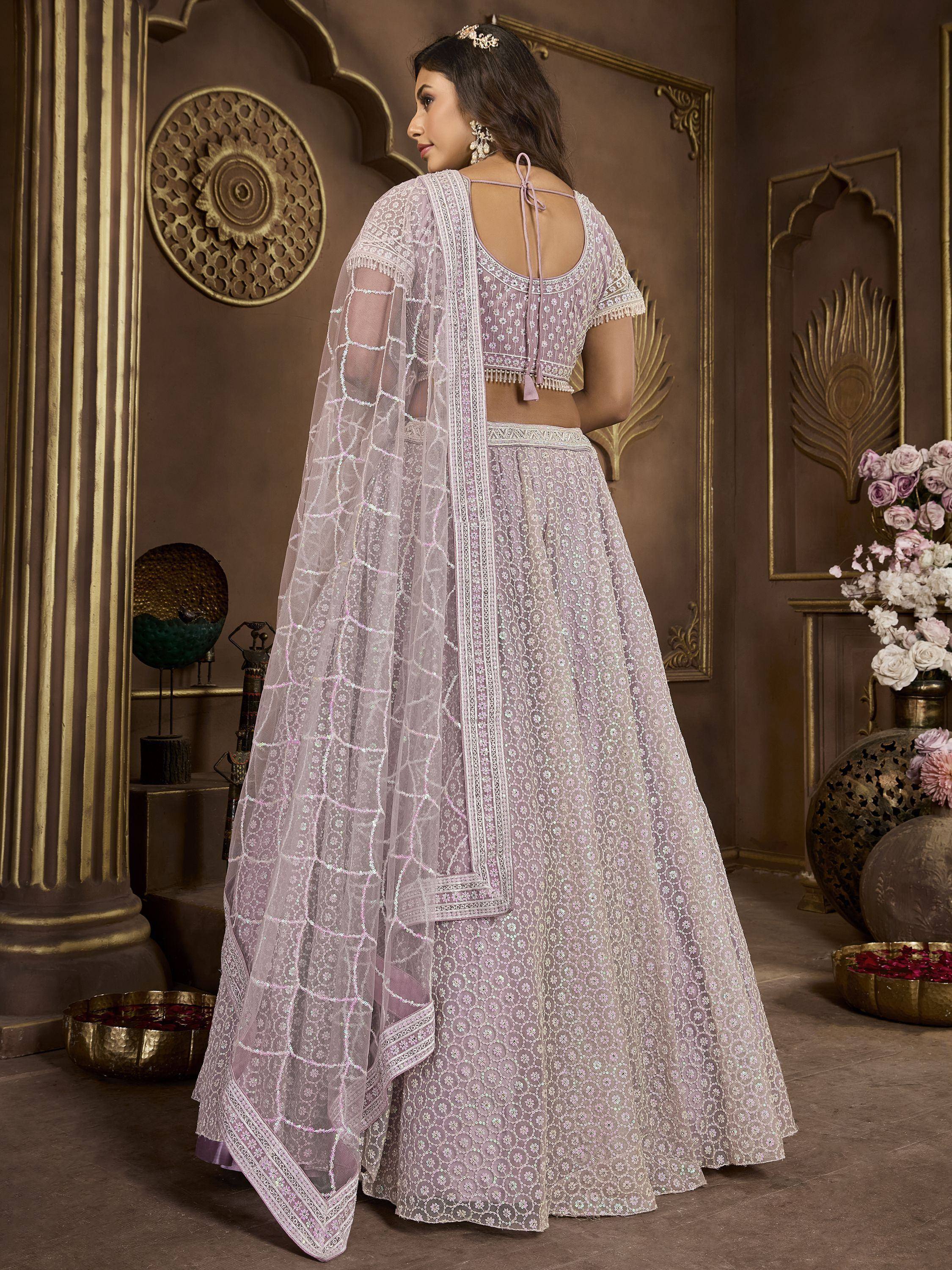 Lavender designer lehenga choli with intricate embroidery and sheer dupatta, perfect for Indian weddings and festive occasions.