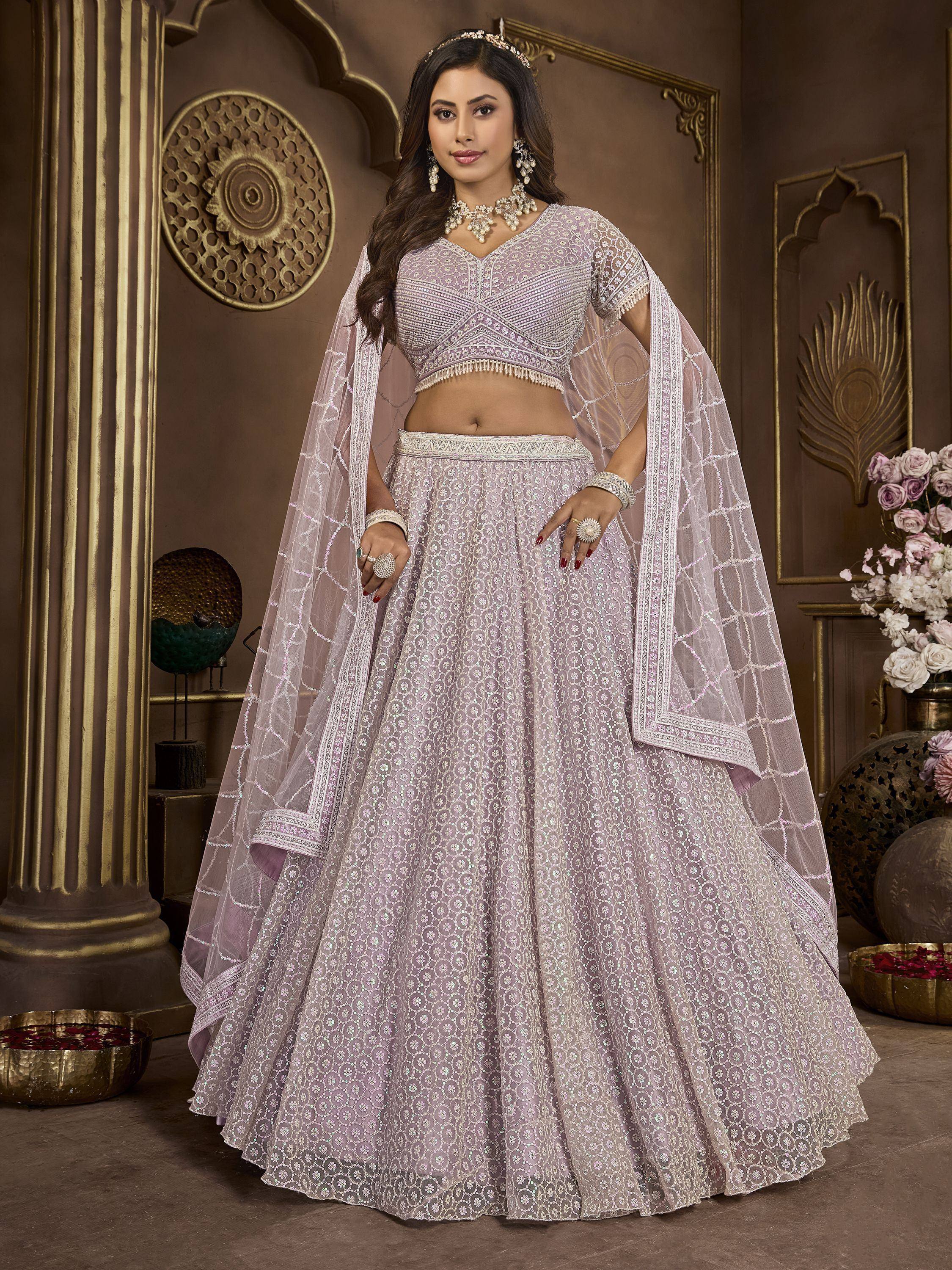 Lavender designer lehenga choli with intricate embroidery and sheer dupatta, perfect for Indian weddings and festive occasions.