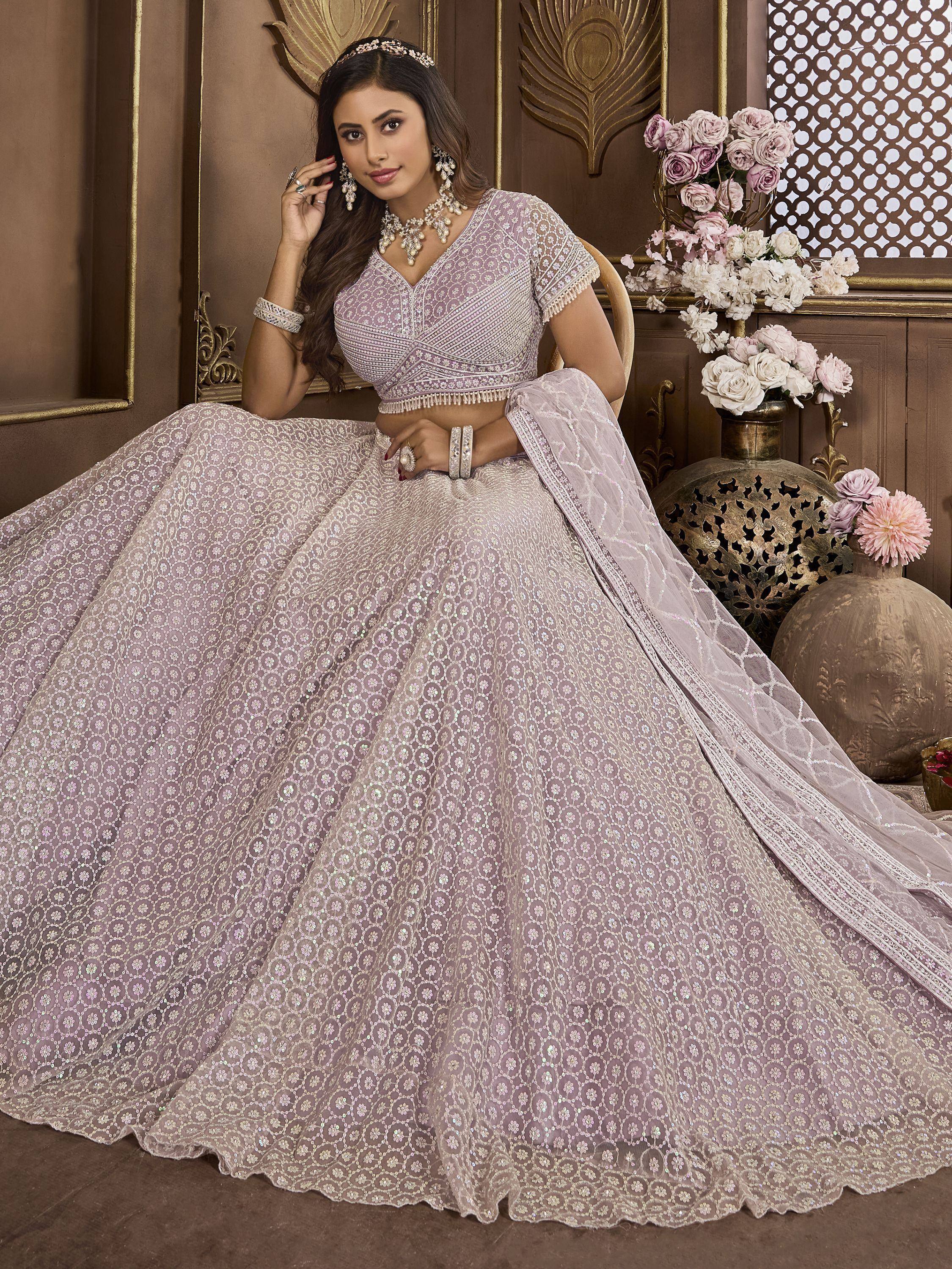 Elegant lavender lehenga choli with intricate embroidery and sequin work, perfect for Indian weddings and festive occasions.