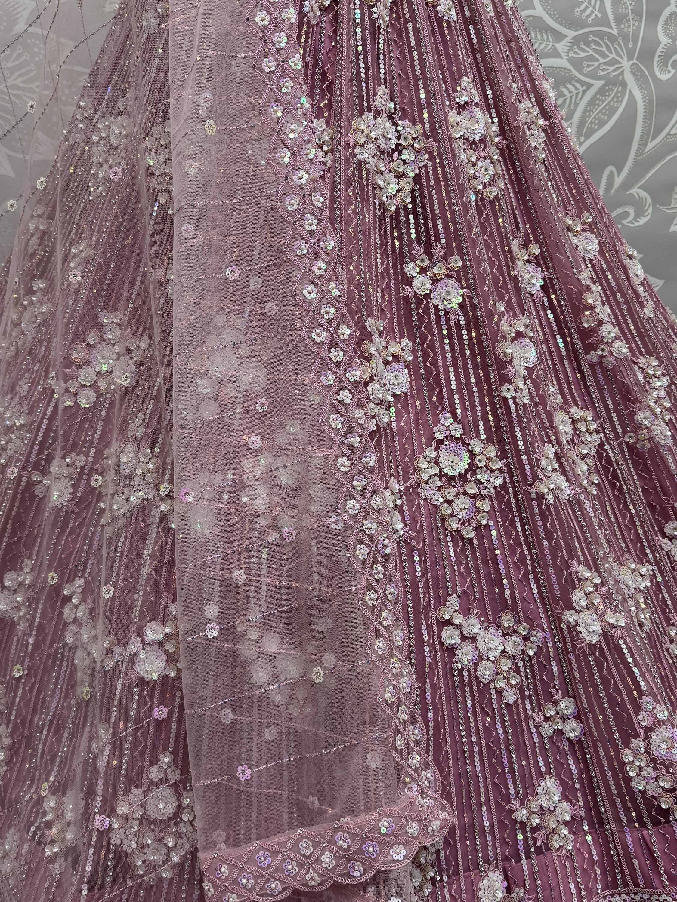 Dusty rose designer lehenga with floral sequin embroidery and sheer overlay, perfect for Indian weddings.