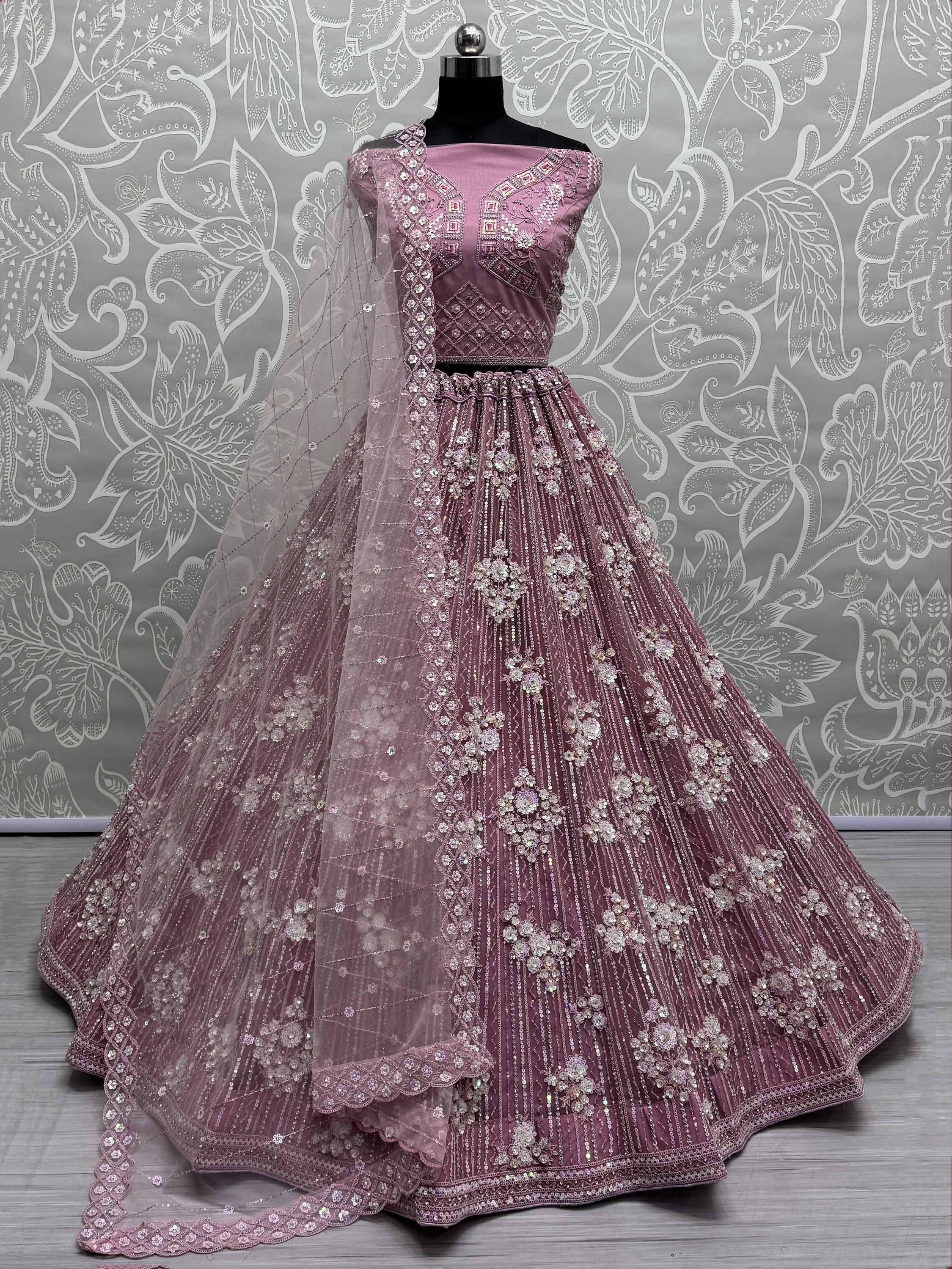Dusty pink designer lehenga choli with heavy embroidery and sequin work, perfect for weddings and parties