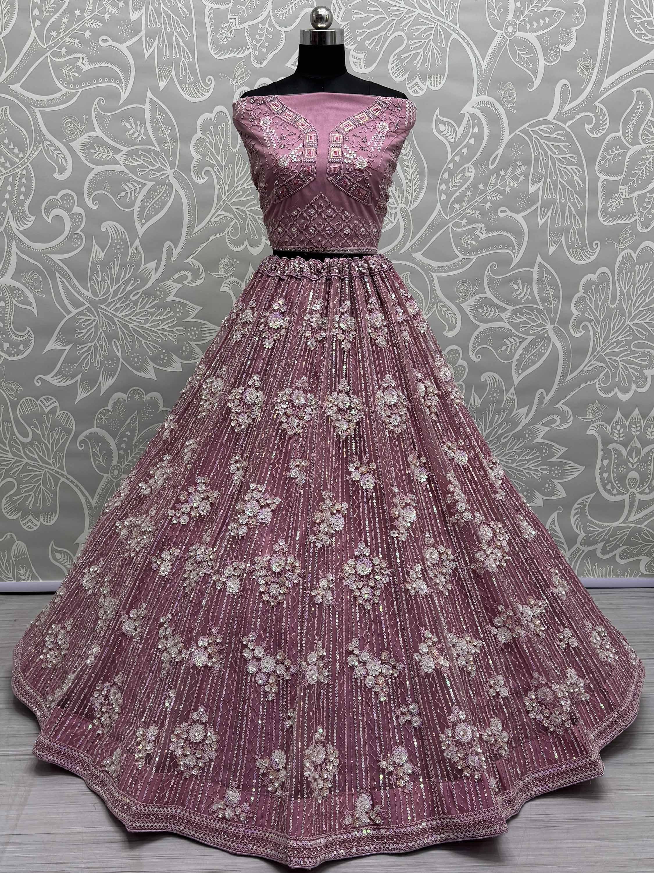 Dusty pink designer lehenga choli with floral embroidery and sequin work, perfect for weddings and festive occasions.