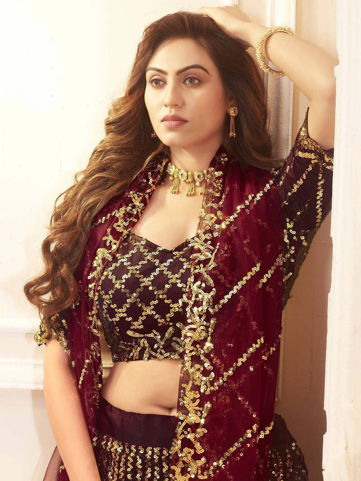 Maroon sequin lehenga choli with gold embroidery, perfect for Indian ethnic wear and festive occasions.