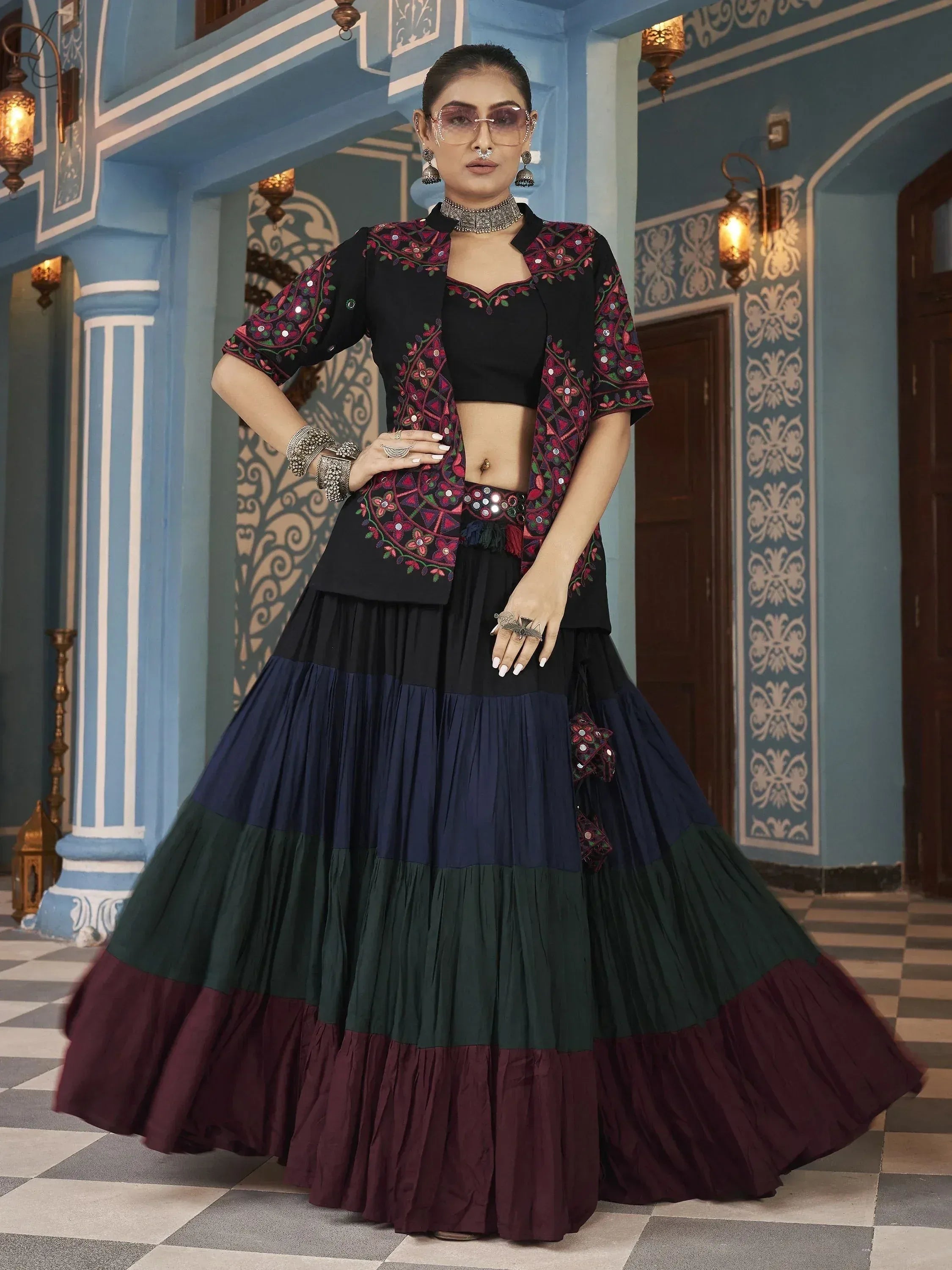 Black embroidered lehenga choli with colorful tiered skirt, perfect for Indian ethnic wear events