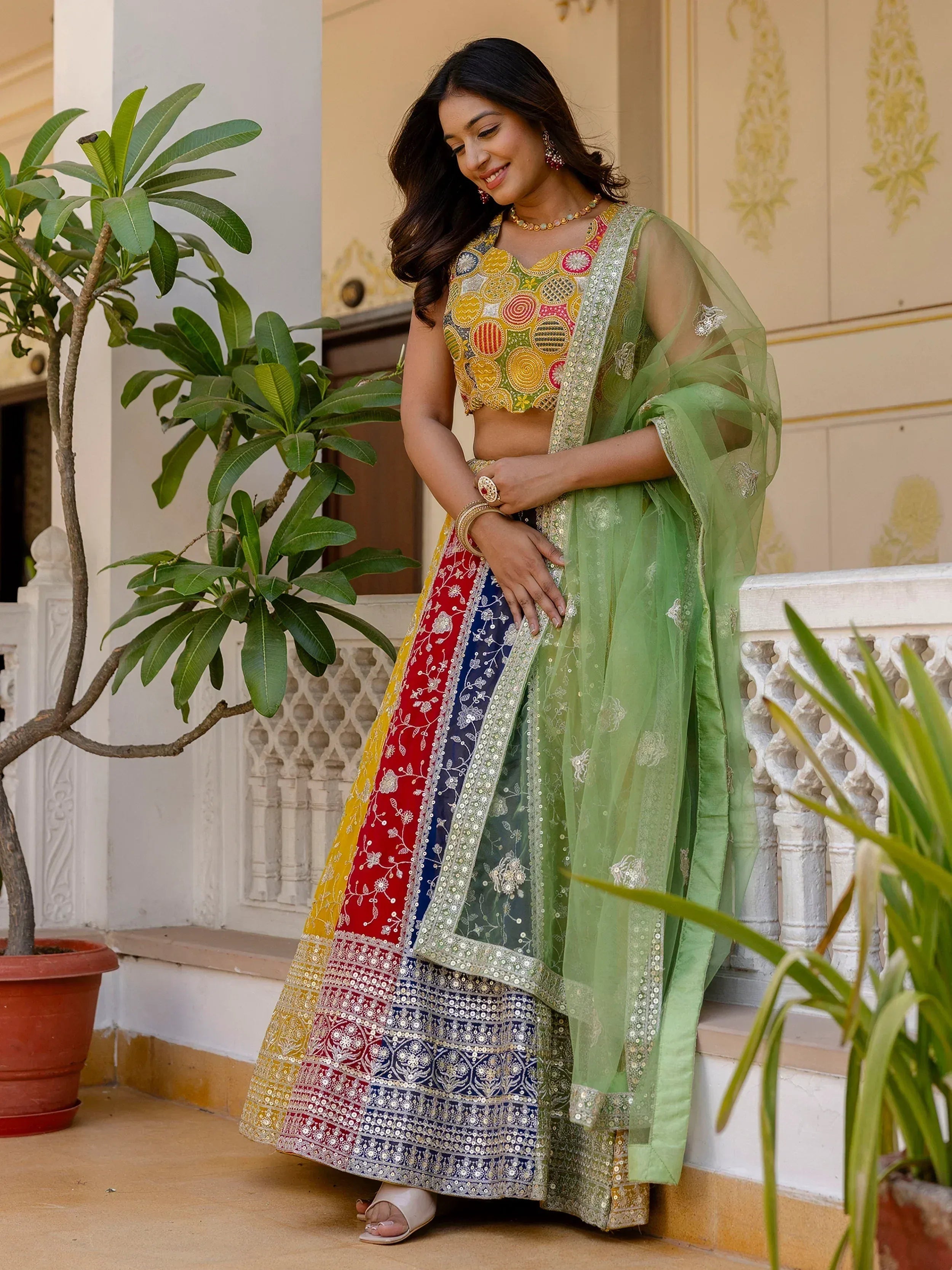 Woman in colorful embroidered lehenga choli with green dupatta, Indian ethnic wear